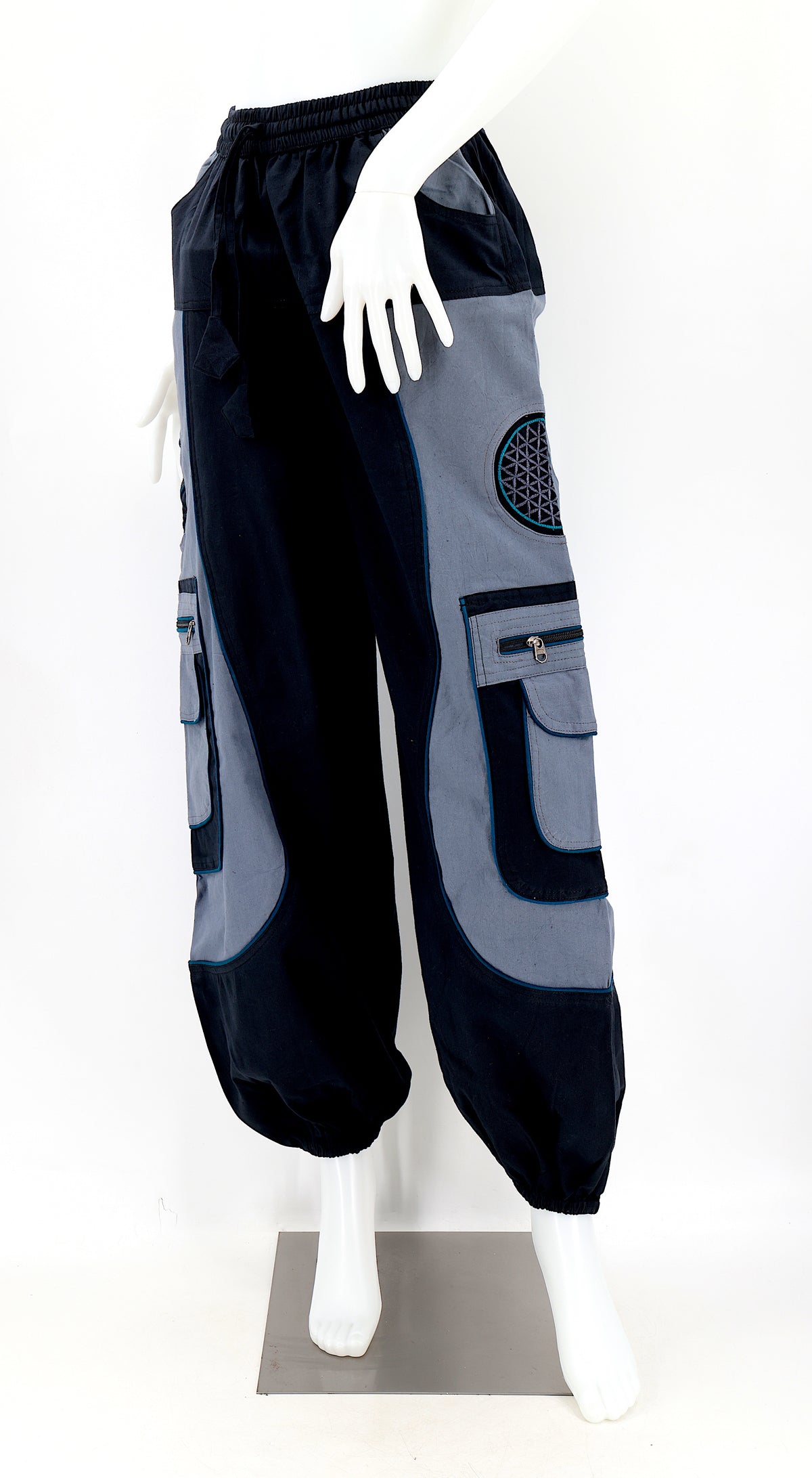 Close-up of black gray embroidered Flower of Life symbol on handmade trousers