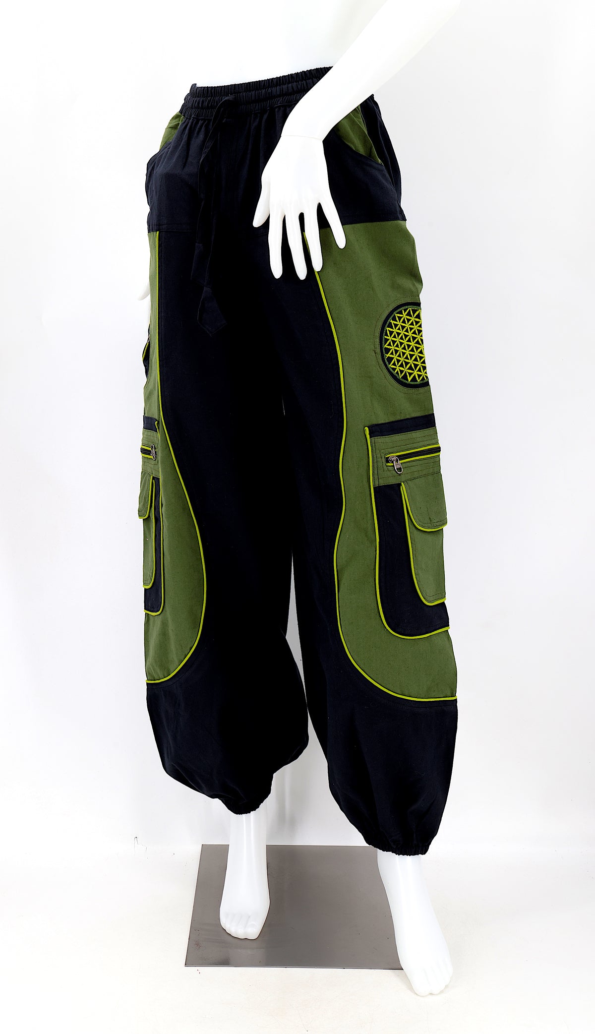 Close-up of black green embroidered Flower of Life symbol on handmade trousers