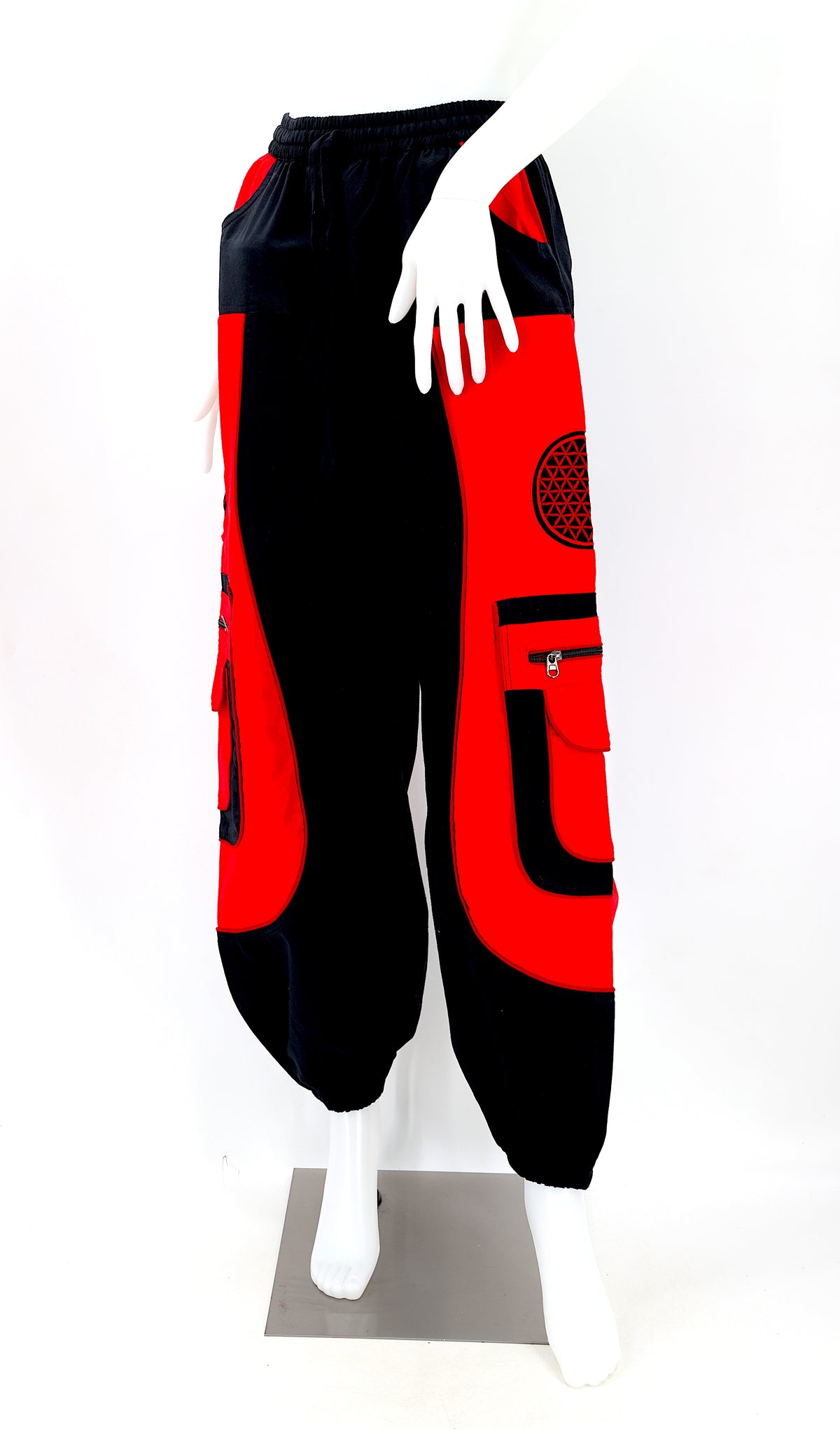 Close-up of black red embroidered Flower of Life symbol on handmade trousers