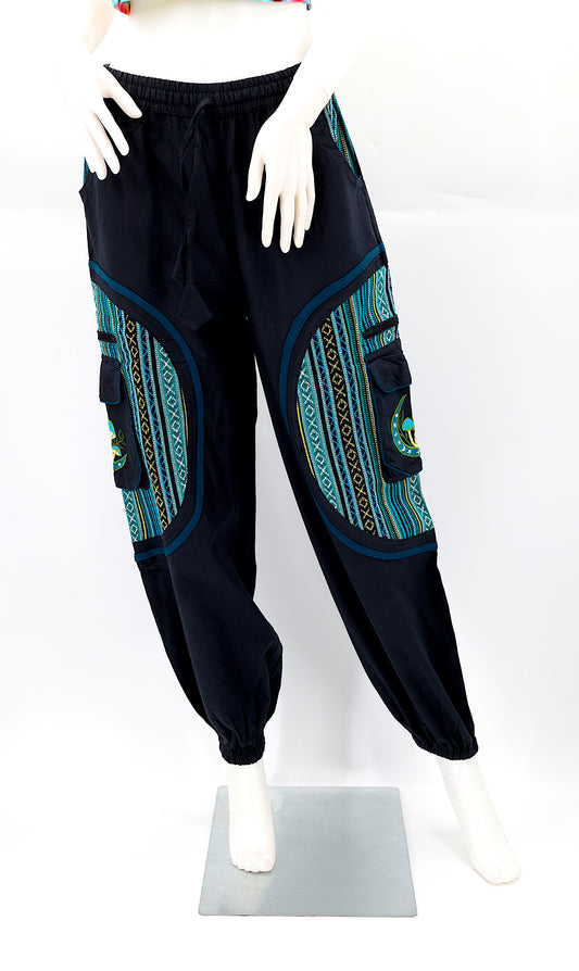 Front view of handmade moon and mushroom embroidered straight-leg harem pants