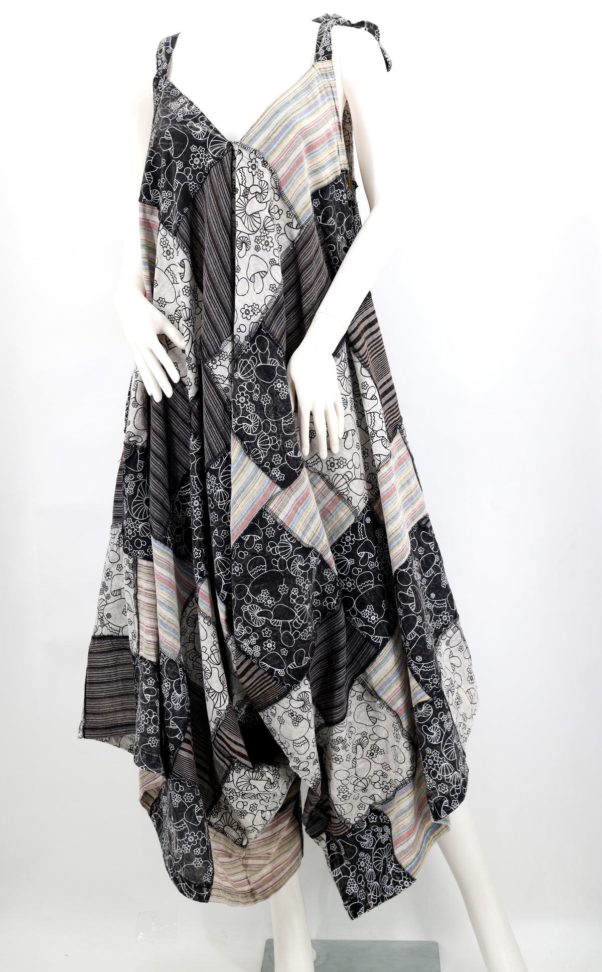 Mannequin wearing a patterned dress with a white background