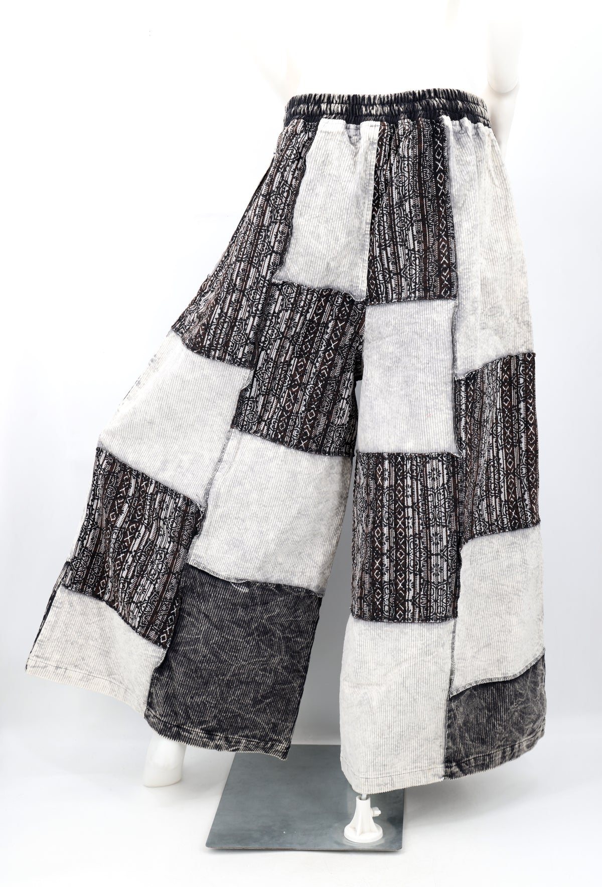 Backside of a patchwork pants on a mannequin against a white background