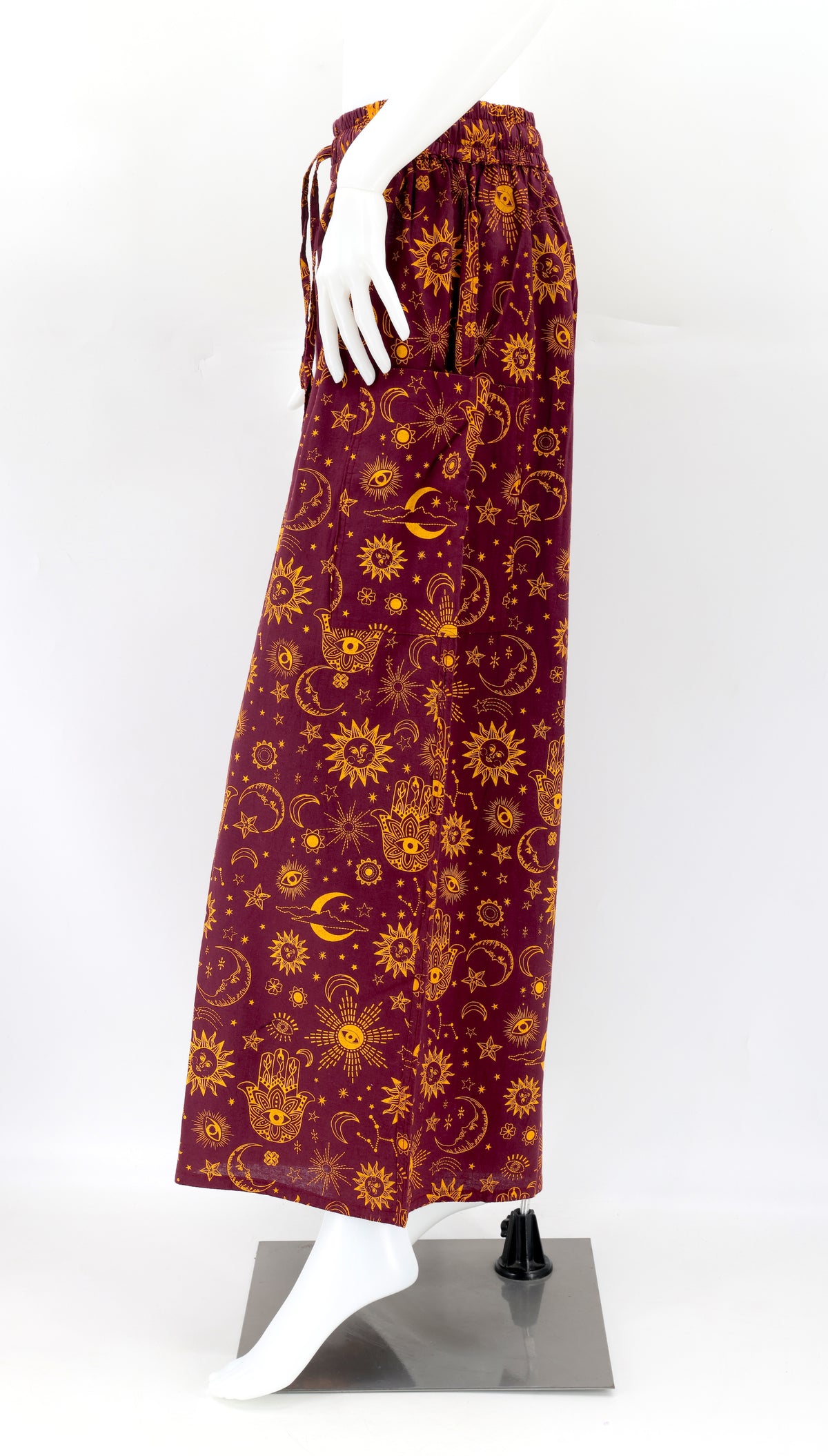 Side view of celestial print harem trousers with deep pocket and relaxed bohemian fit
