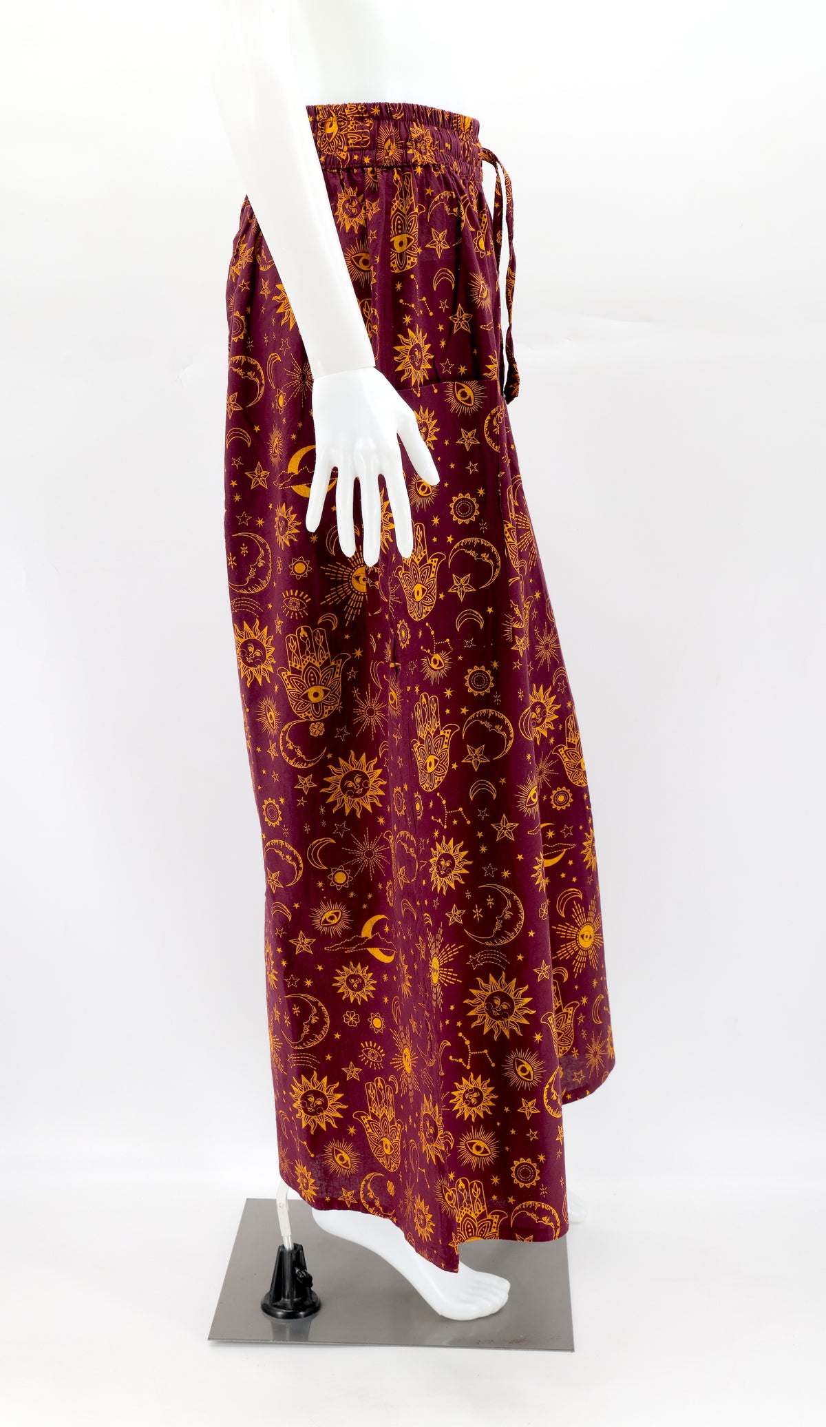 Side view of celestial print harem trousers with deep pocket and relaxed bohemian fit