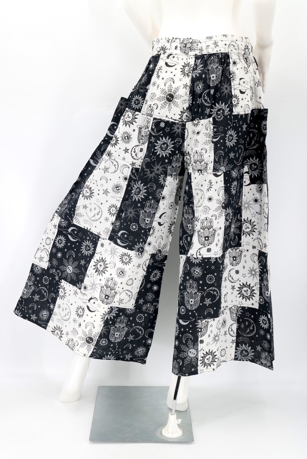 Back view showing unique patchwork pattern and relaxed fit of celestial print harem trousers