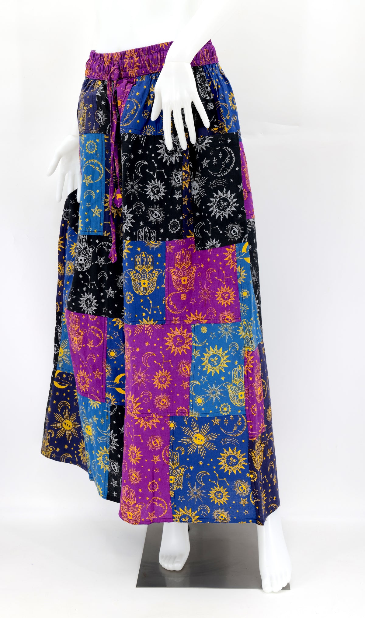 Detail of vibrant handwoven cotton patchwork with celestial motifs on bohemian harem pants