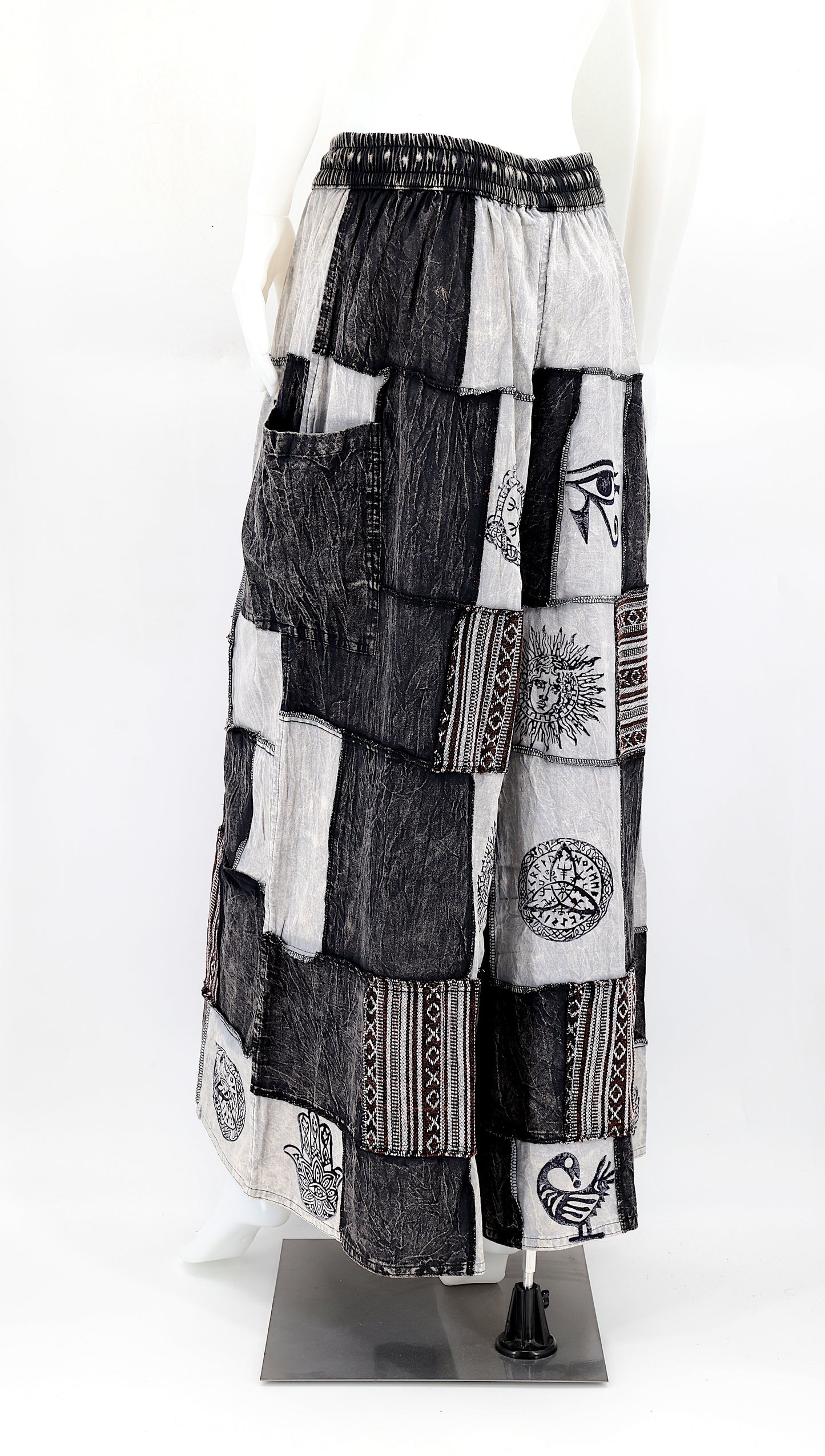 Back view of wide-leg cotton harem pants featuring ancient symbol designs