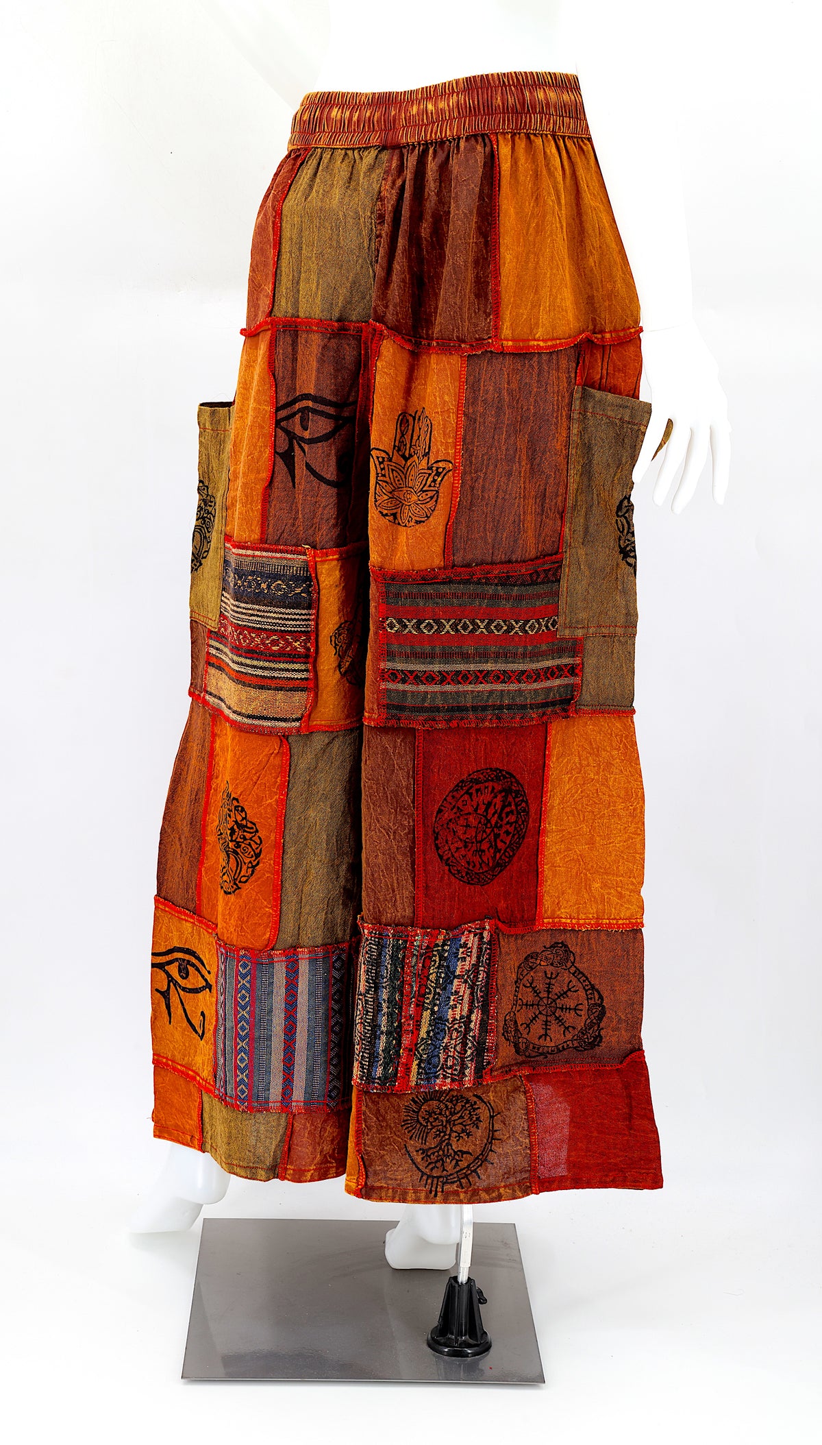 Back view of wide-leg cotton harem pants featuring ancient symbol designs