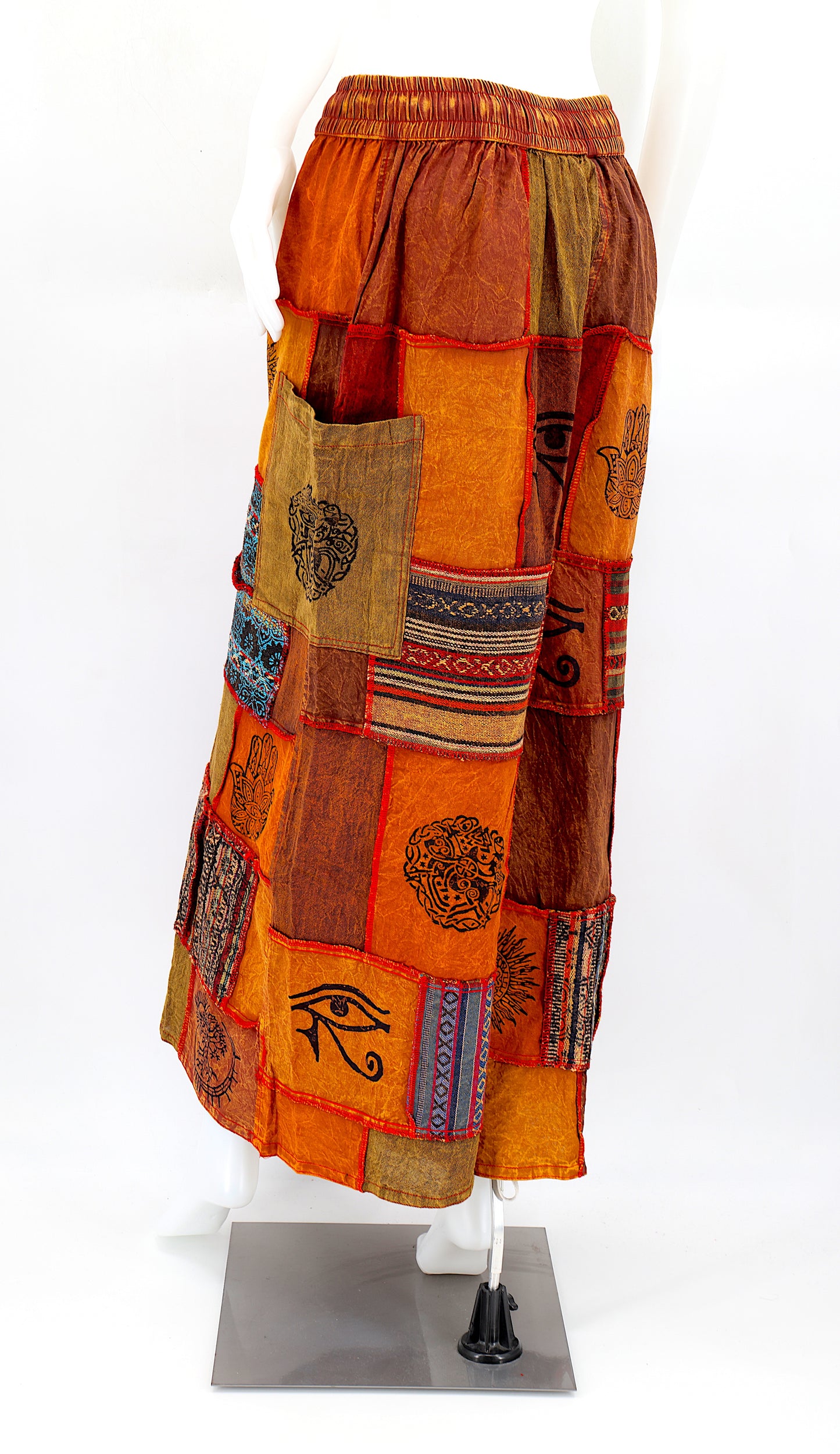 Back view of wide-leg cotton harem pants featuring ancient symbol designs