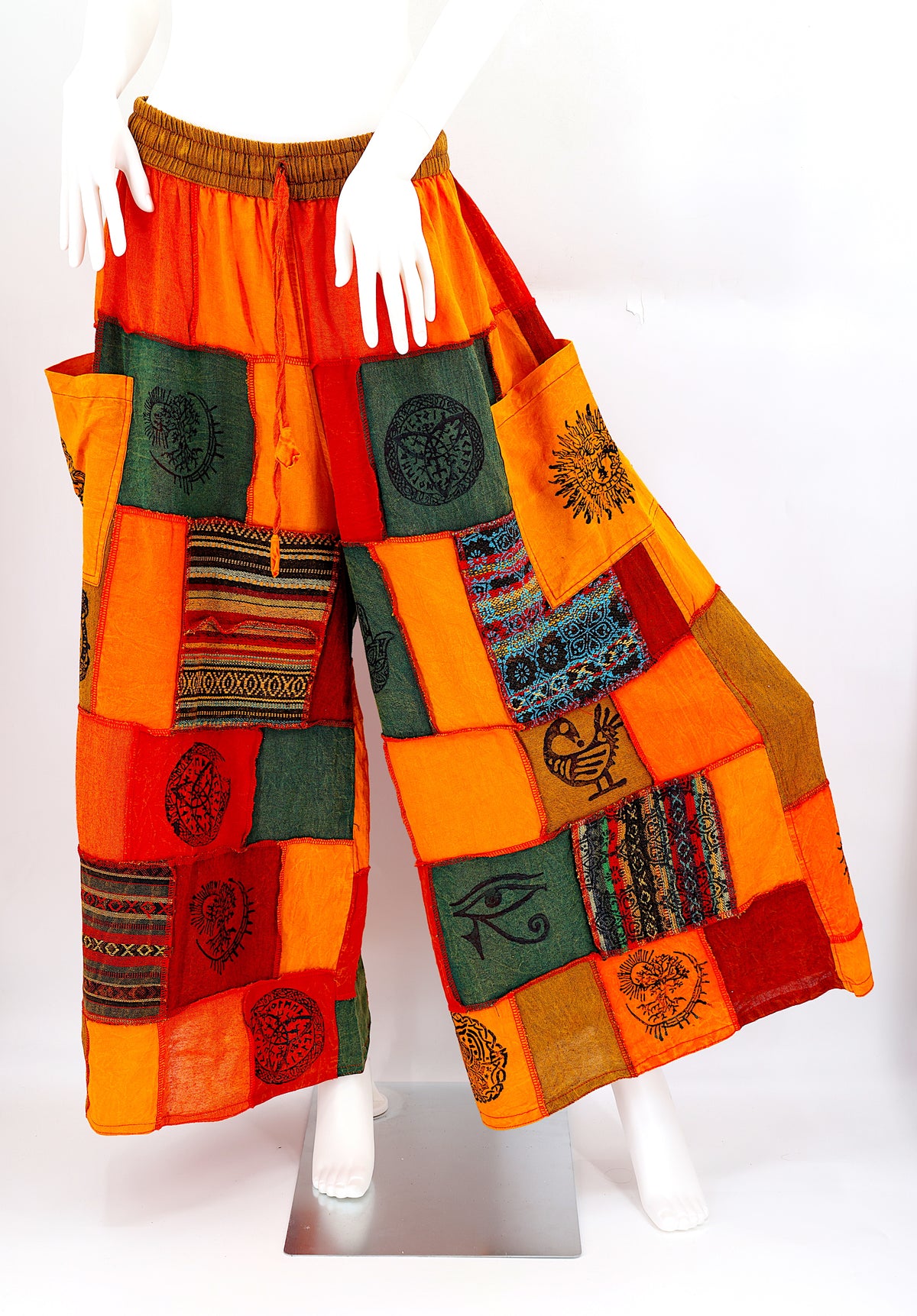 Bohemian harem pants with Old Gods symbolic patchwork and wide-leg design, handmade from natural cotton
