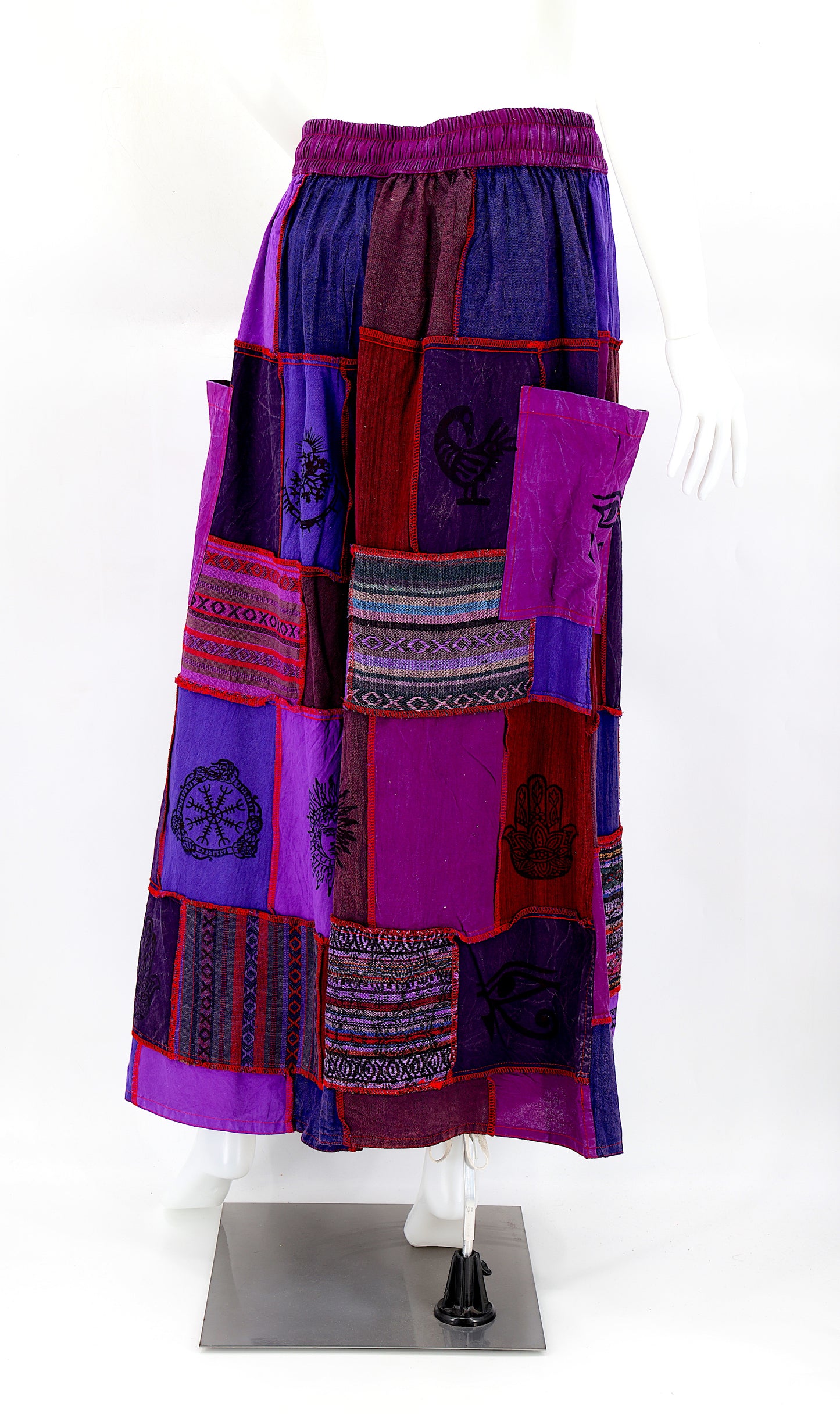 Back view of wide-leg cotton harem pants featuring ancient symbol designs