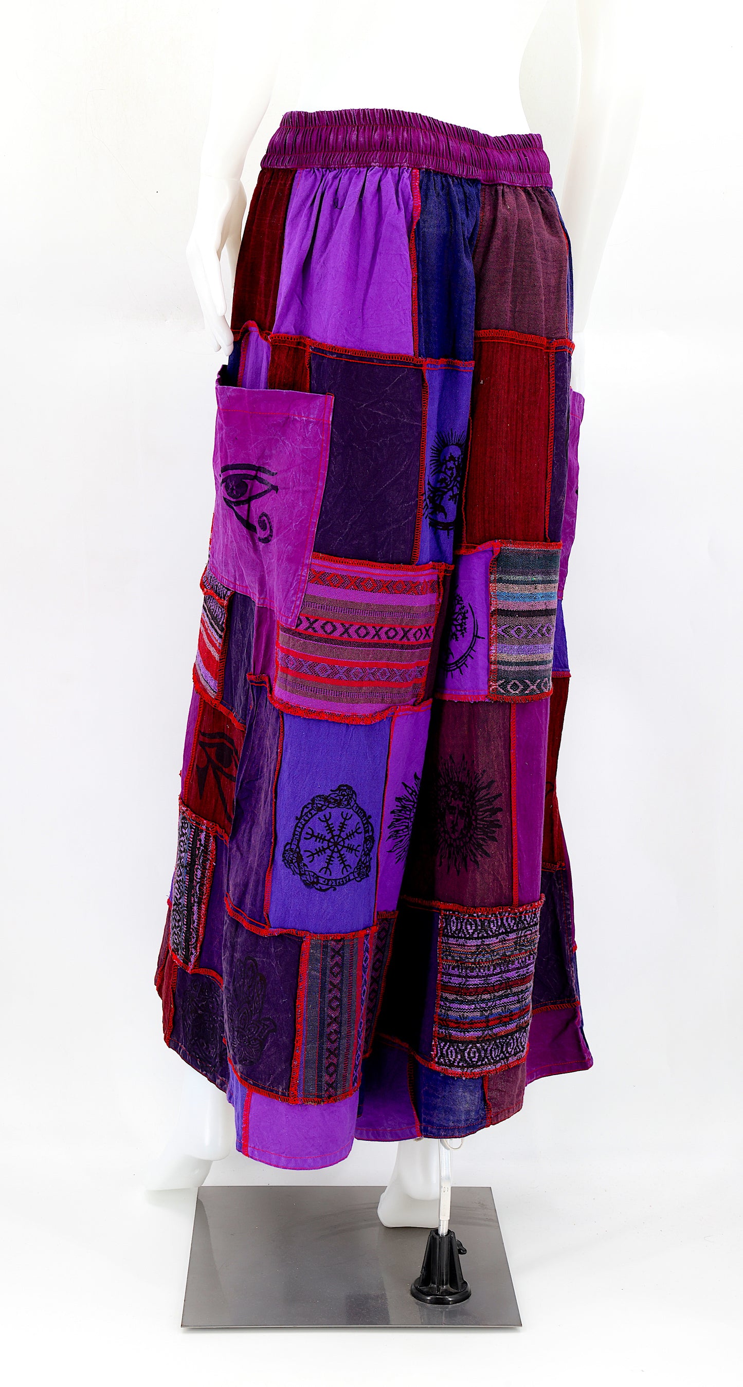 Back view of wide-leg cotton harem pants featuring ancient symbol designs
