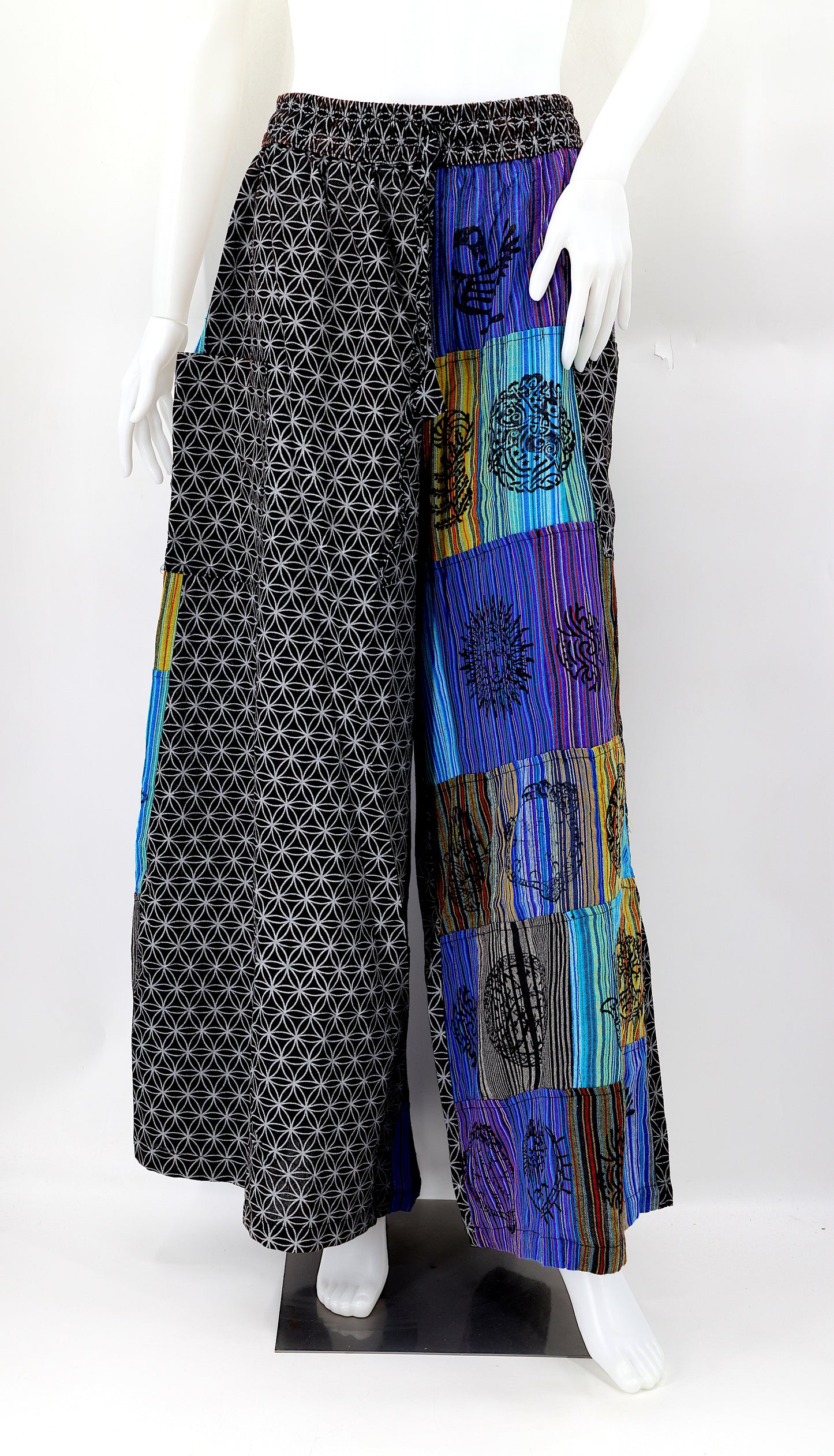 Front view of handmade Flower of Life patchwork wide-leg harem pants with pagan symbol block prints