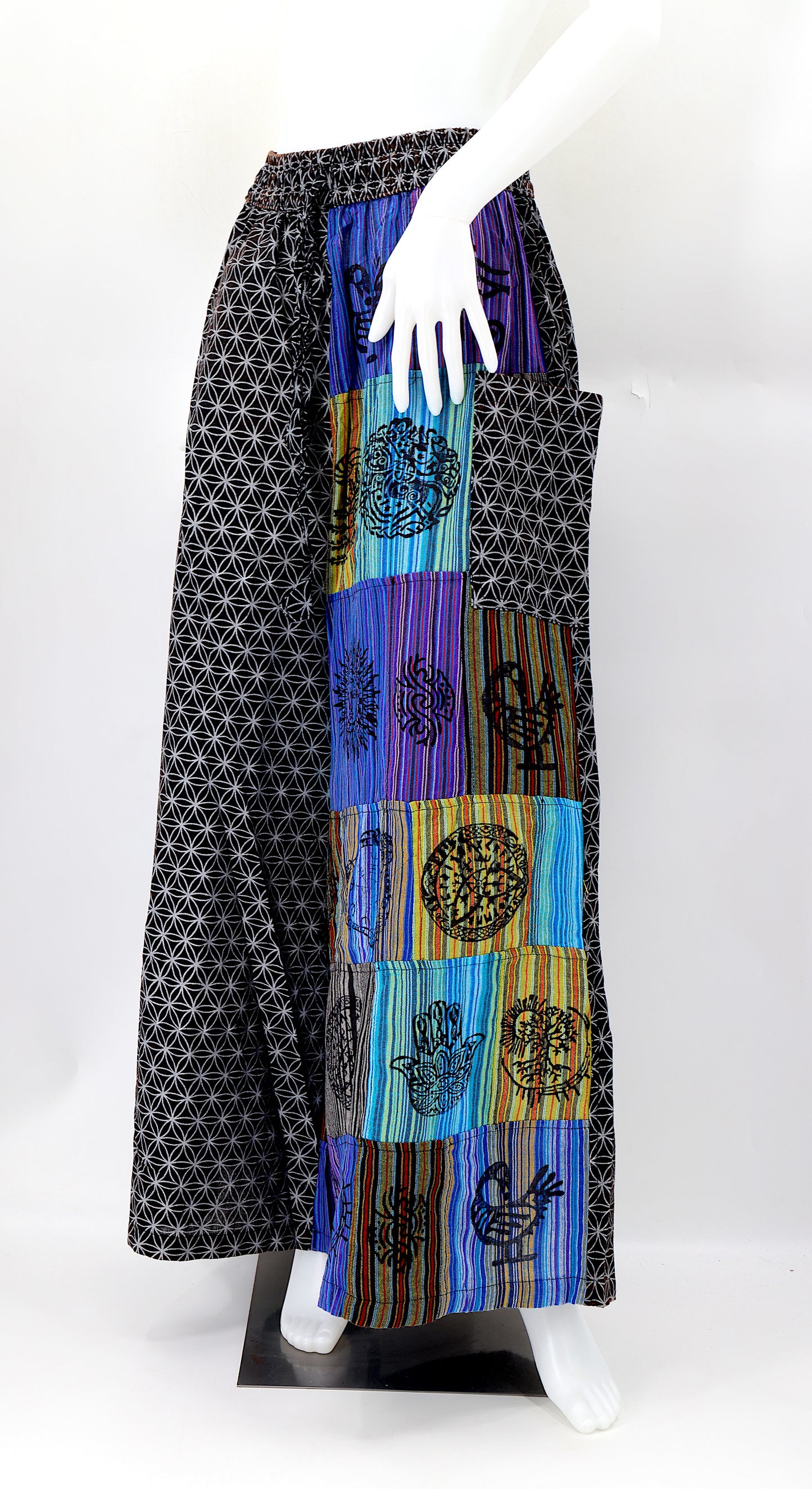 Front view of handmade Flower of Life patchwork wide-leg harem pants with pagan symbol block prints