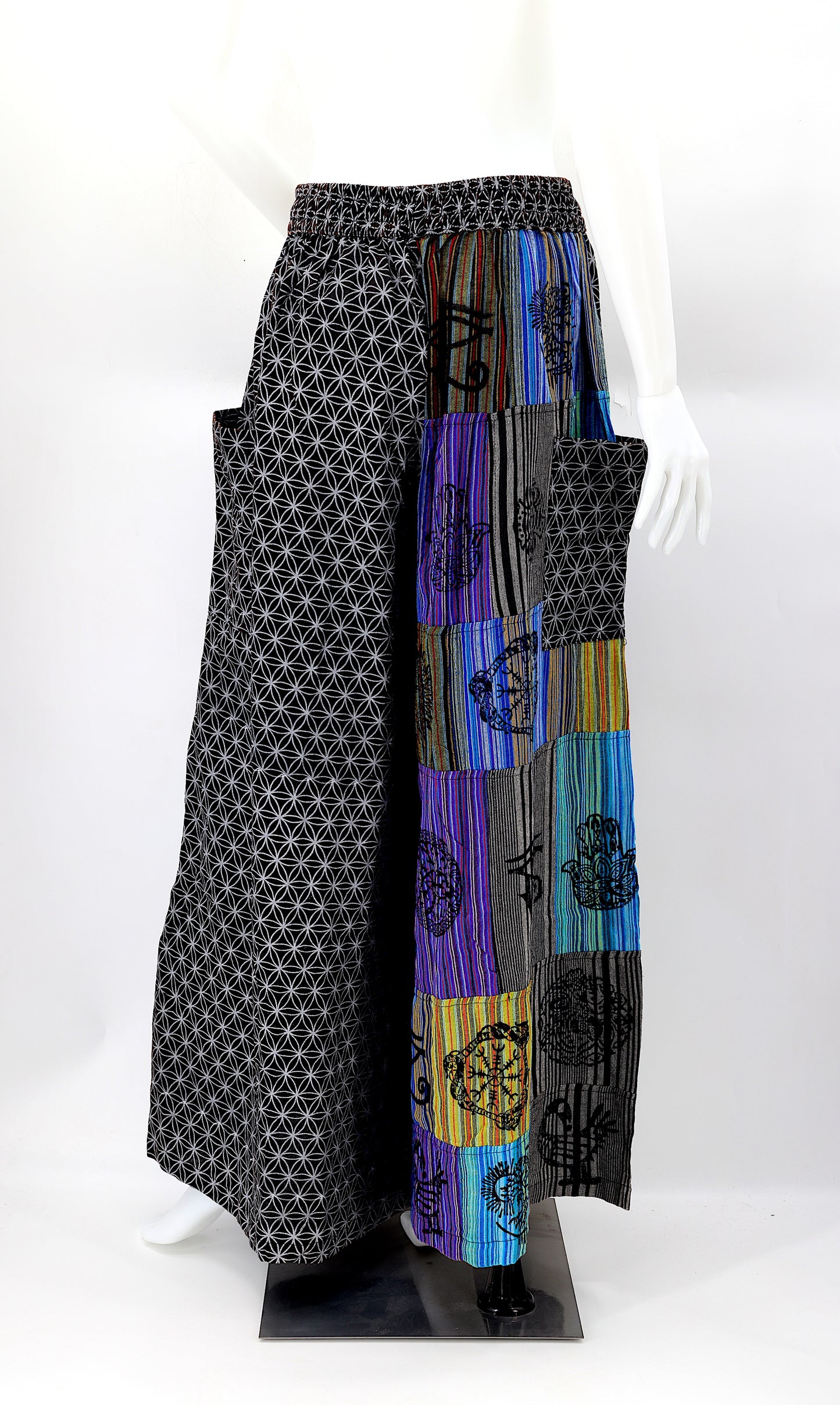 Back view of unique patchwork design featuring pagan symbols on wide-leg cotton harem trousers