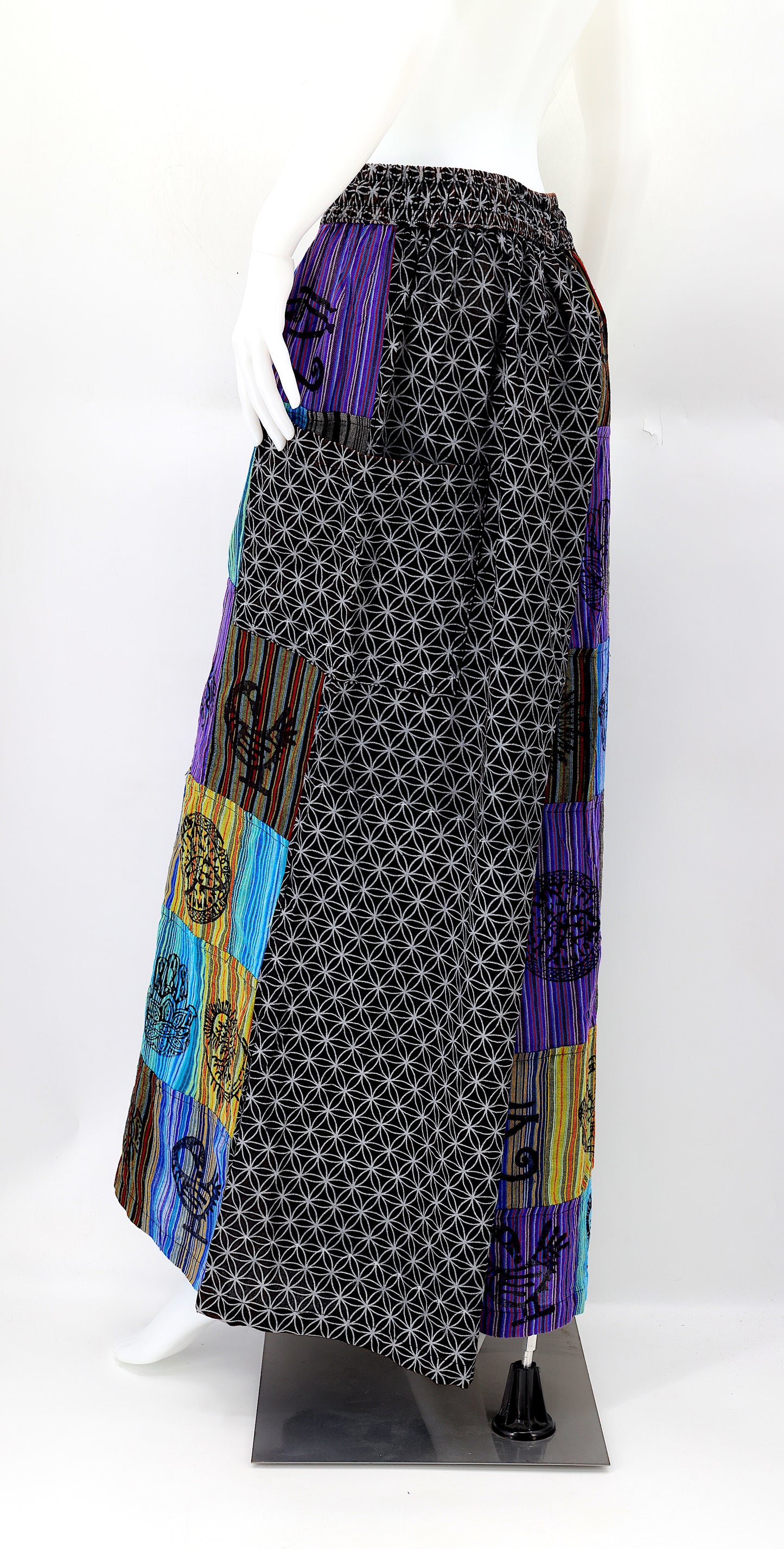 Back view of unique patchwork design featuring pagan symbols on wide-leg cotton harem trousers