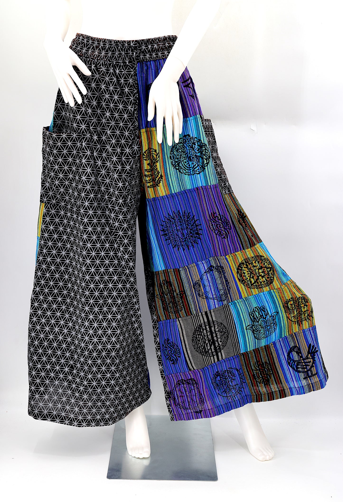 Front view of handmade Flower of Life patchwork wide-leg harem pants with pagan symbol block prints
