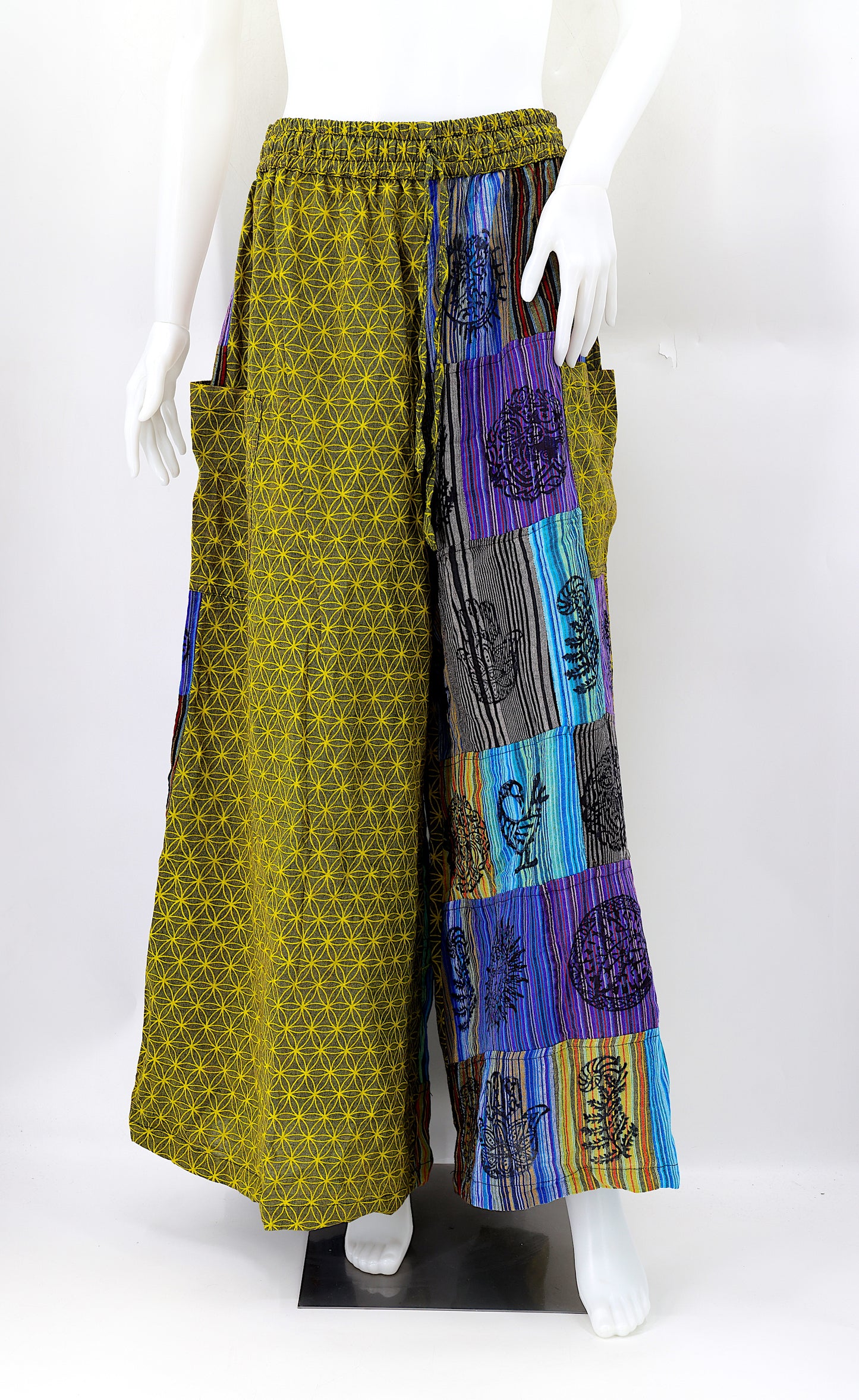 Front view of handmade Flower of Life patchwork wide-leg harem pants with pagan symbol block prints