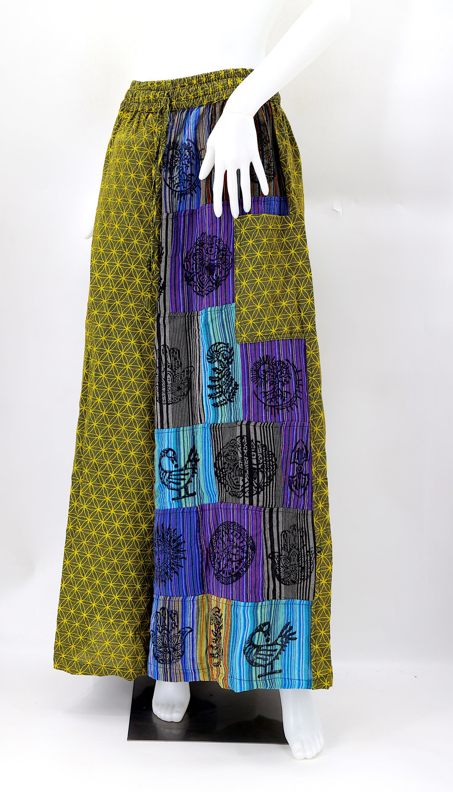 Front view of handmade Flower of Life patchwork wide-leg harem pants with pagan symbol block prints