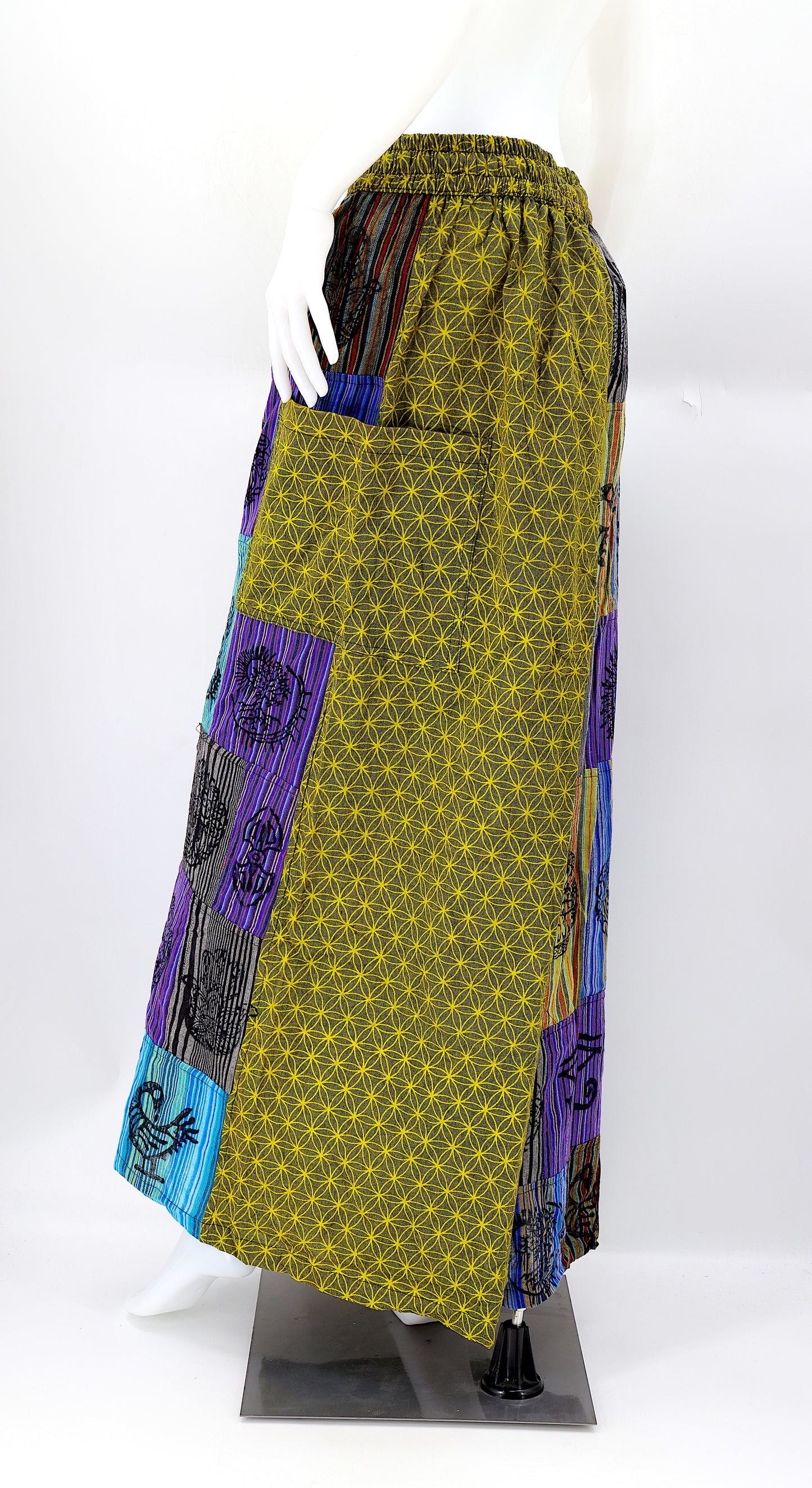 Back view of unique patchwork design featuring pagan symbols on wide-leg cotton harem trousers