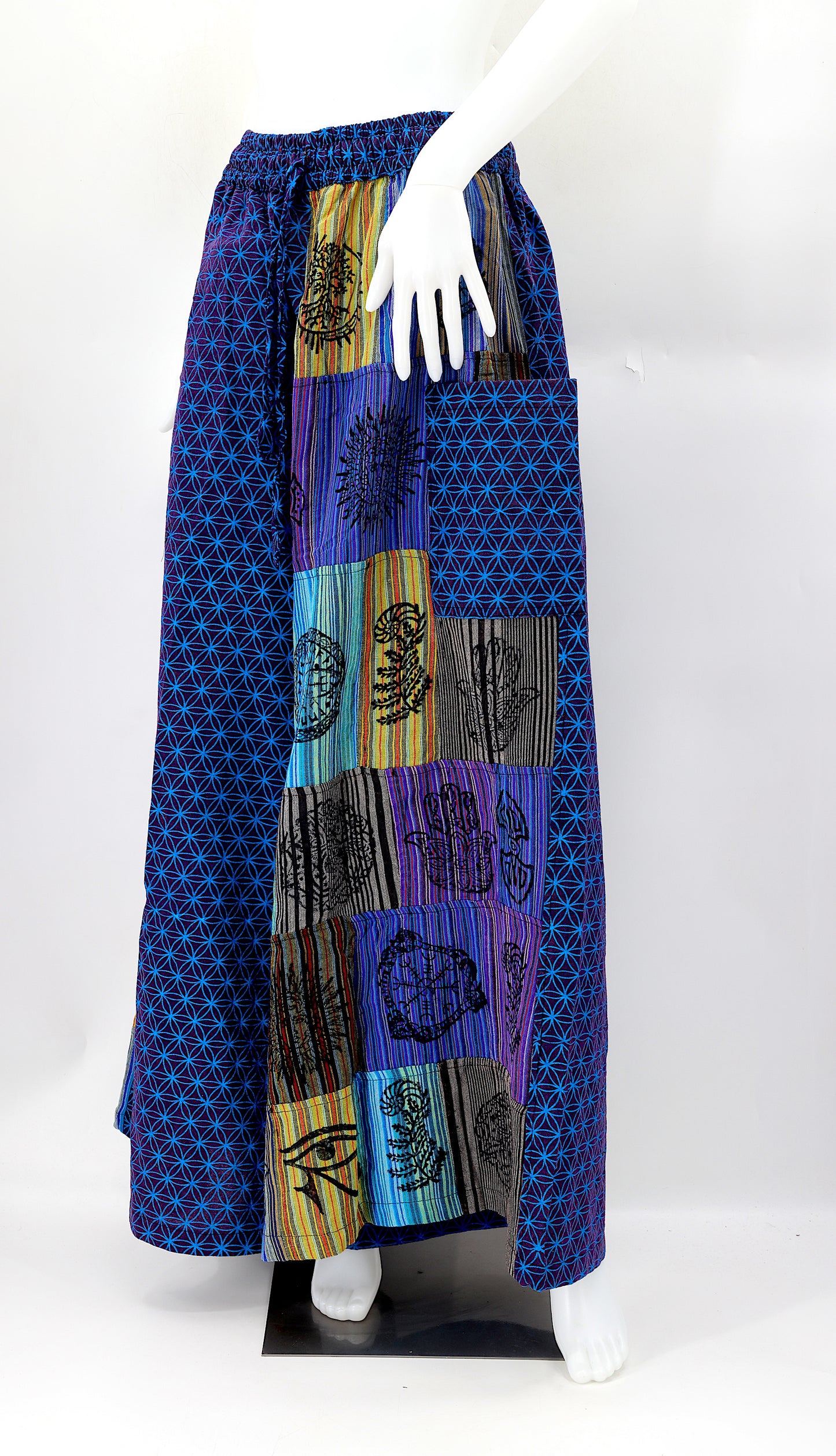 Front view of handmade Flower of Life patchwork wide-leg harem pants with pagan symbol block prints