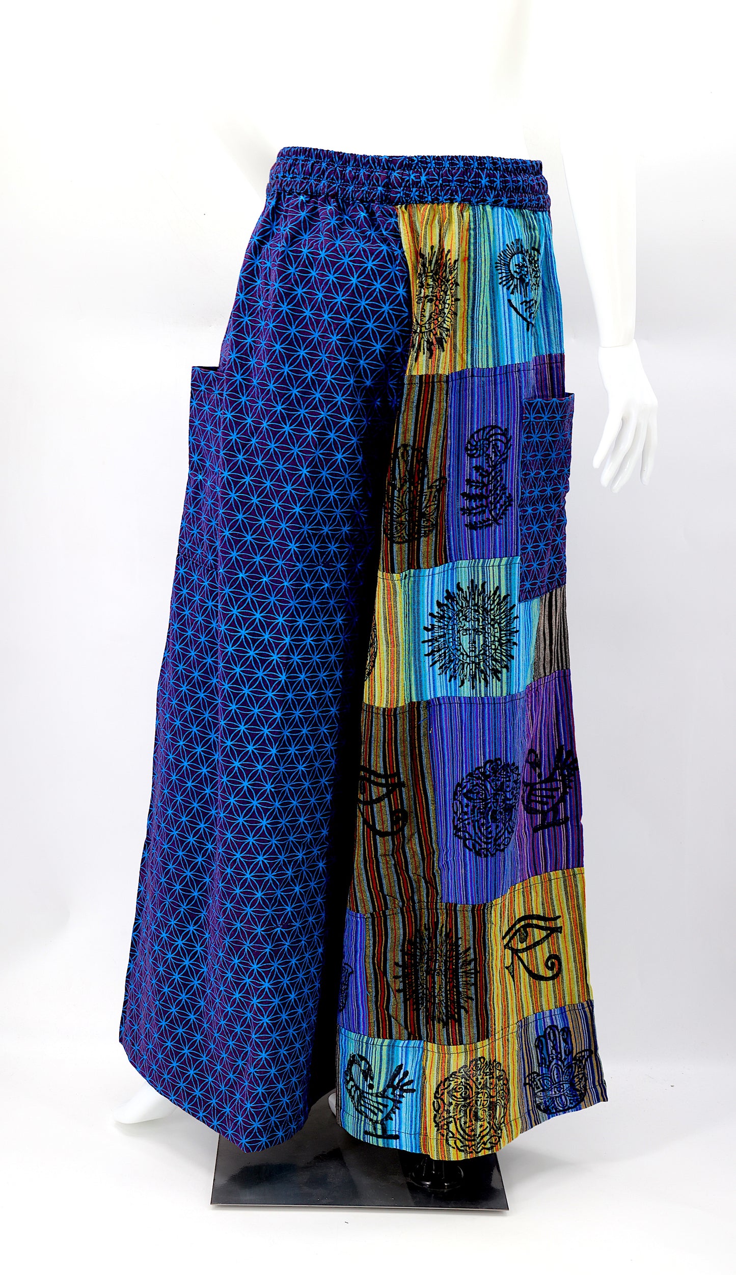 Back view of unique patchwork design featuring pagan symbols on wide-leg cotton harem trousers