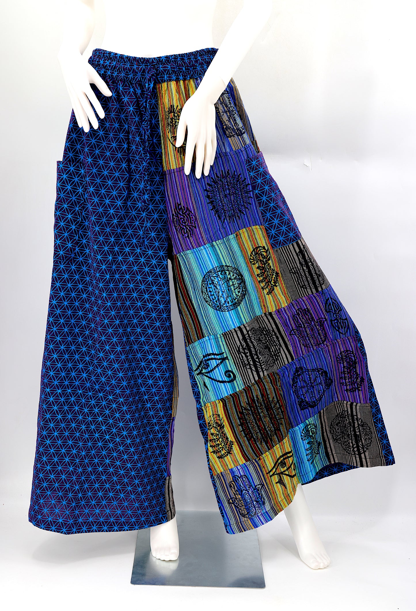 Front view of handmade Flower of Life patchwork wide-leg harem pants with pagan symbol block prints