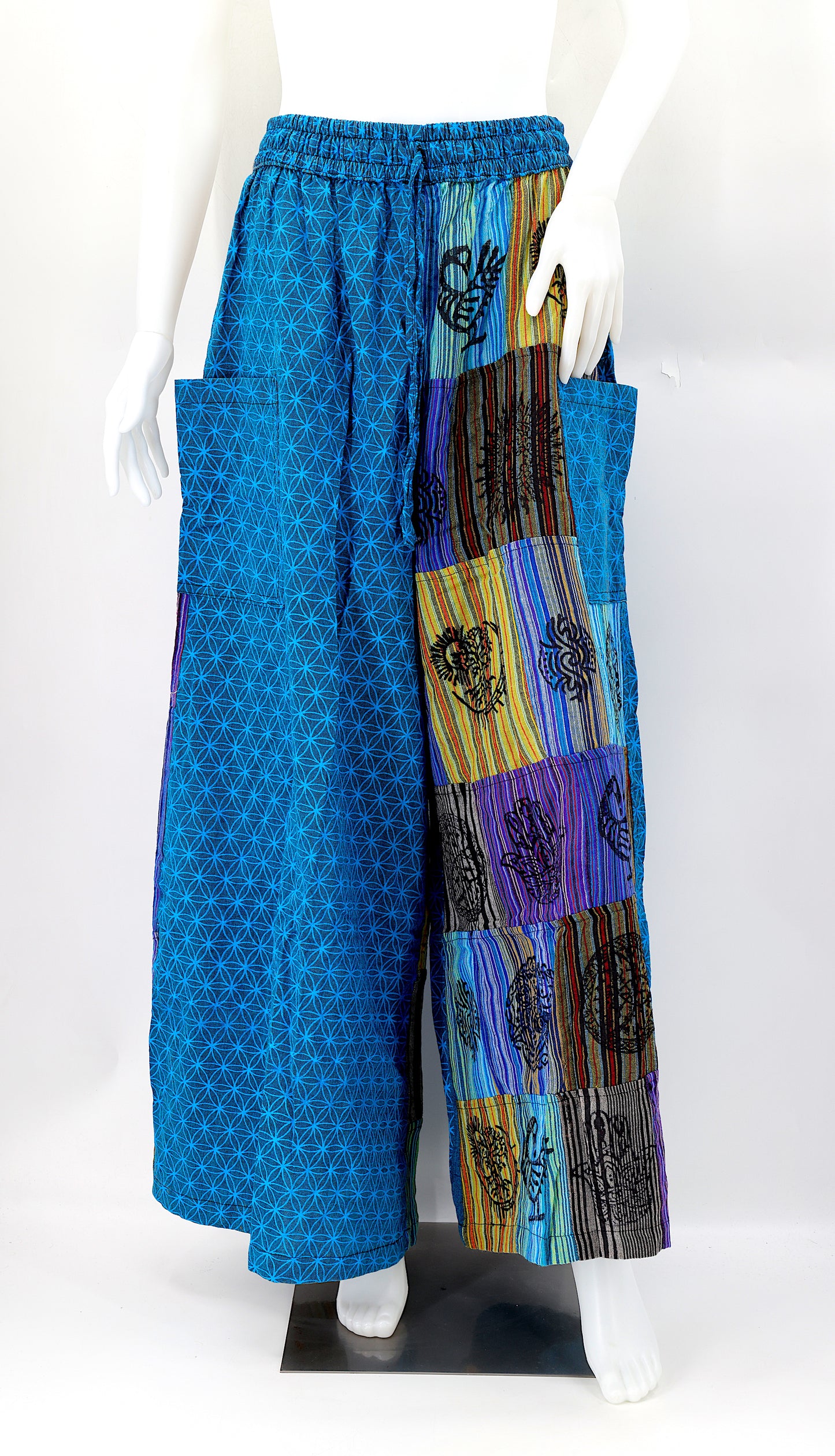 Front view of handmade Flower of Life patchwork wide-leg harem pants with pagan symbol block prints