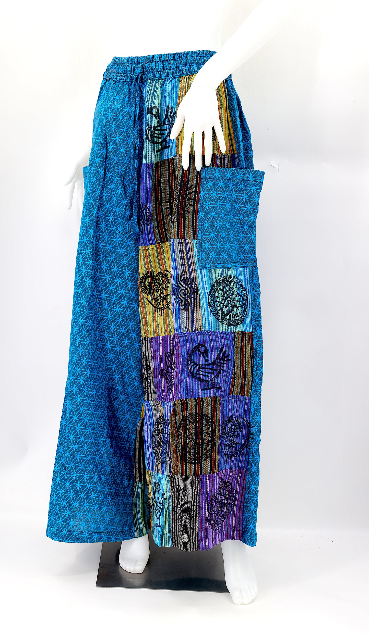 Front view of handmade Flower of Life patchwork wide-leg harem pants with pagan symbol block prints