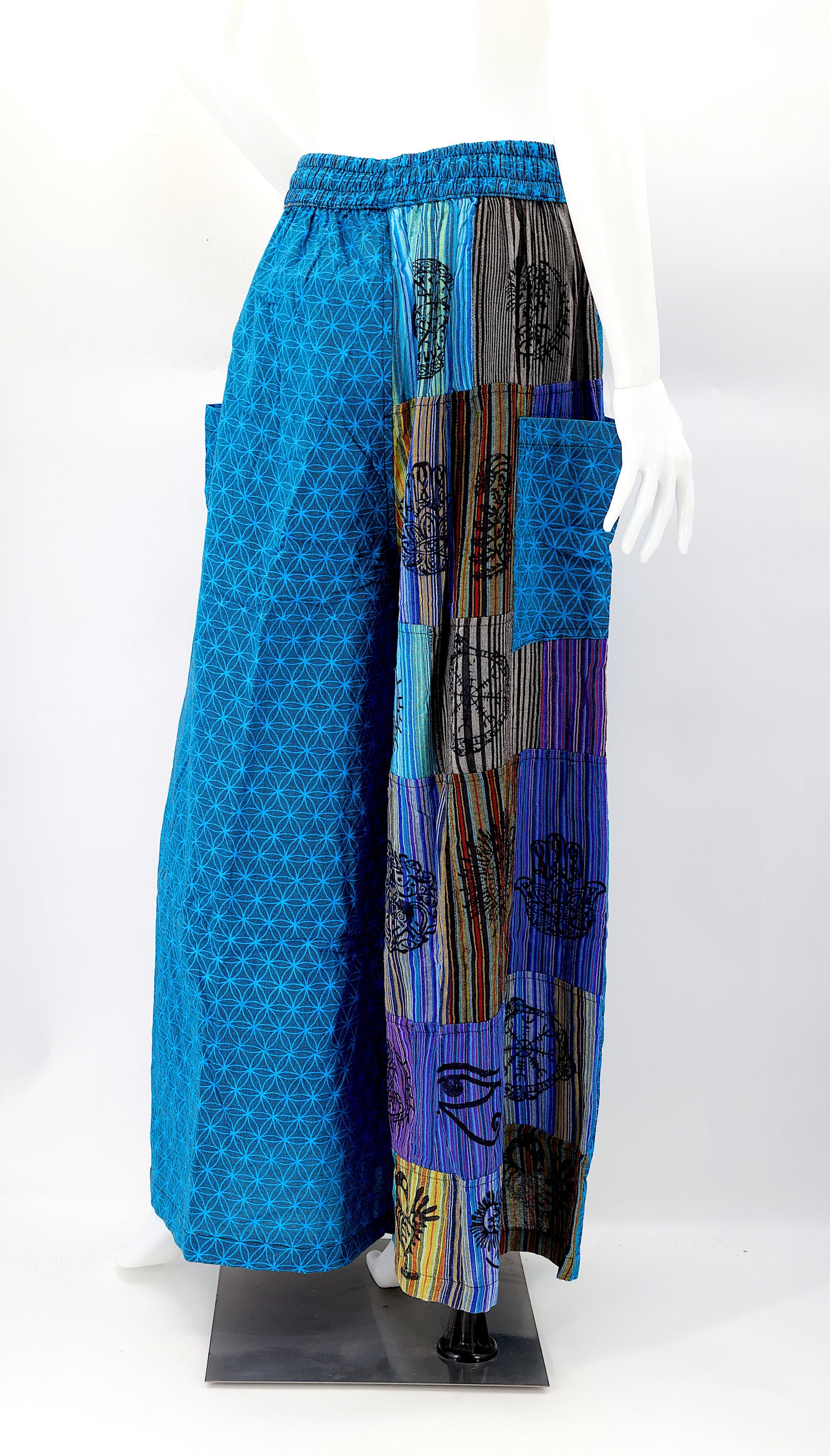 Back view of unique patchwork design featuring pagan symbols on wide-leg cotton harem trousers
