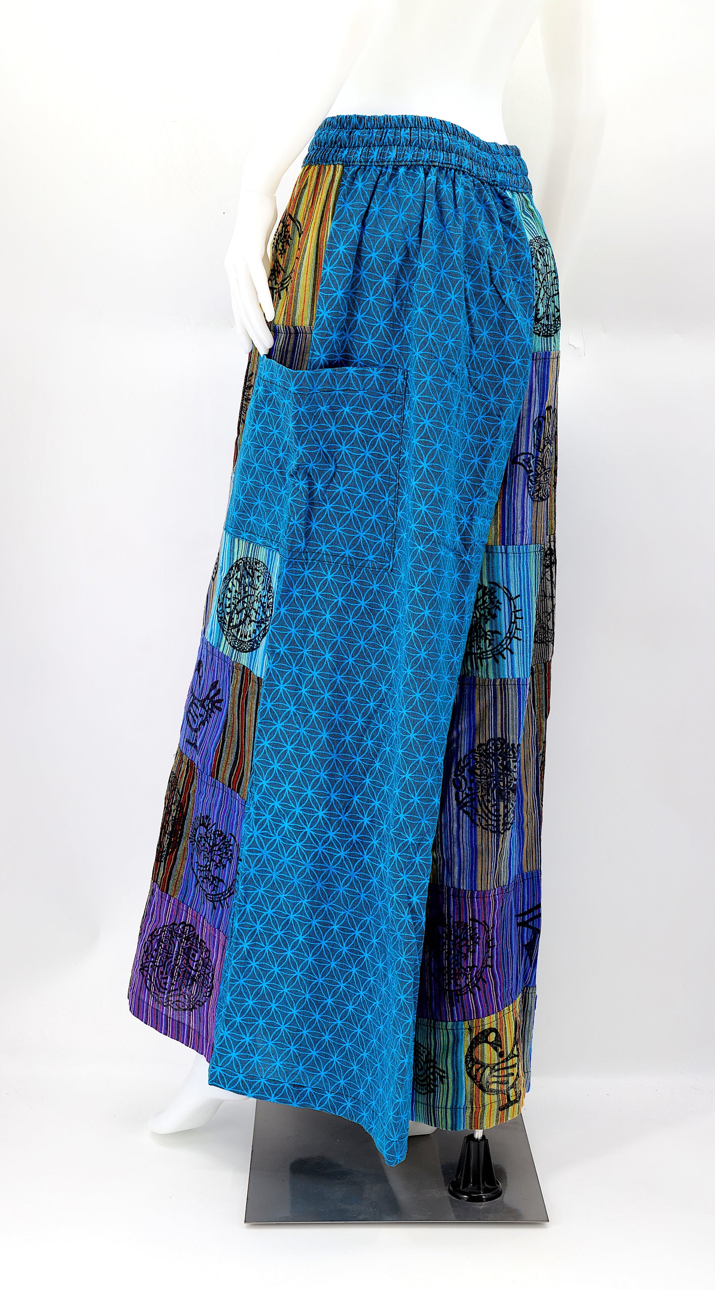Back view of unique patchwork design featuring pagan symbols on wide-leg cotton harem trousers