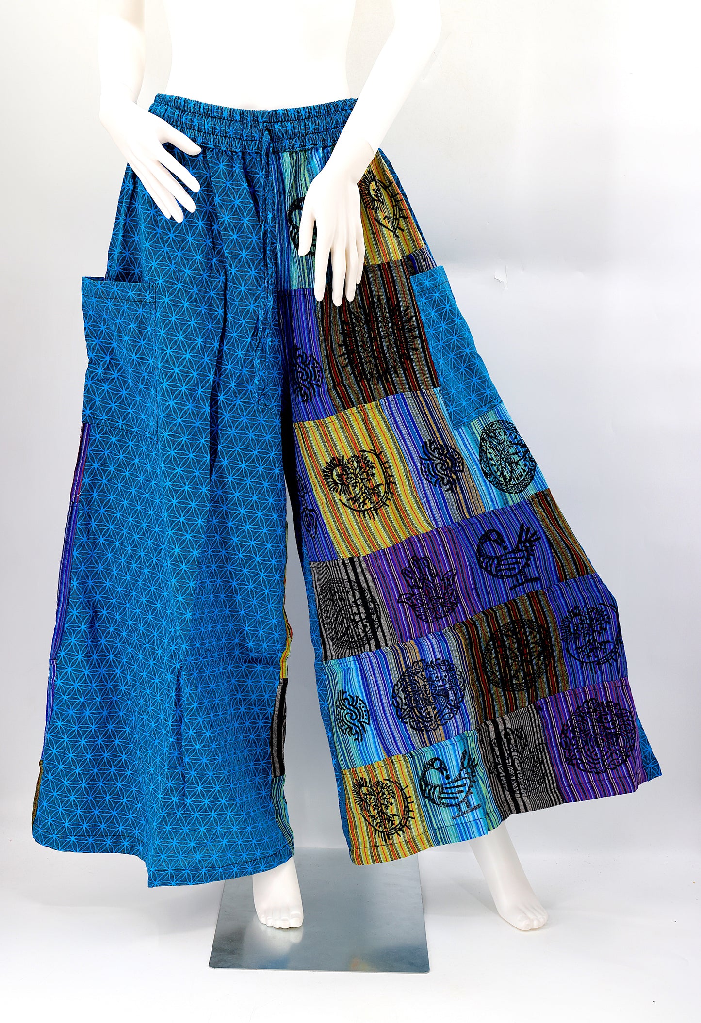 Front view of handmade Flower of Life patchwork wide-leg harem pants with pagan symbol block prints