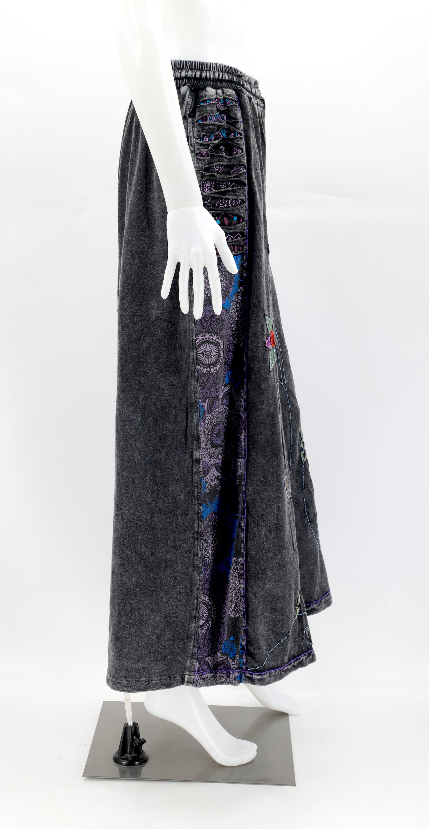 Side view of wide-leg pants showing deep functional pockets and flowing silhouette.