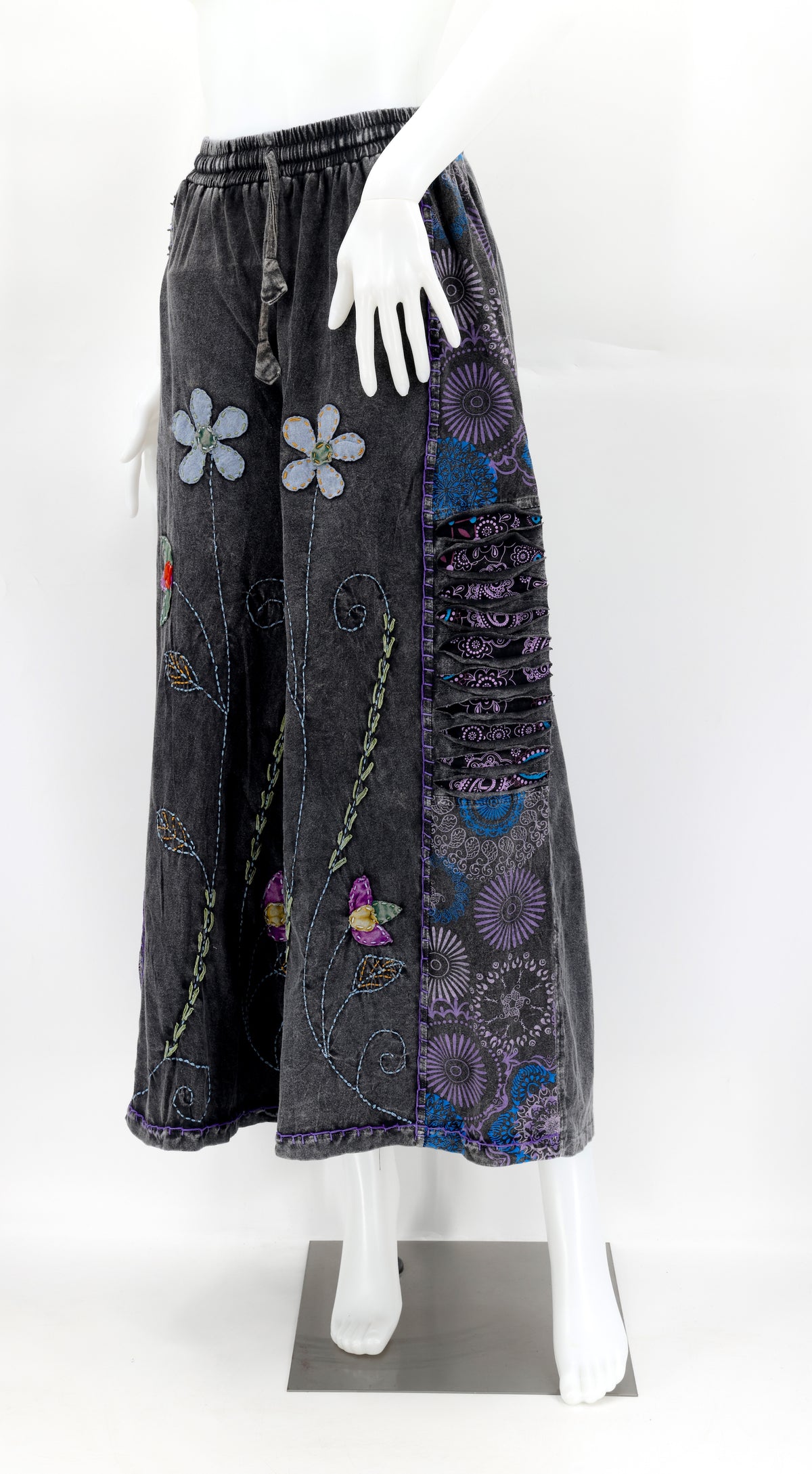 Front view of handmade floral embroidered wide-leg cotton trousers in natural tones.