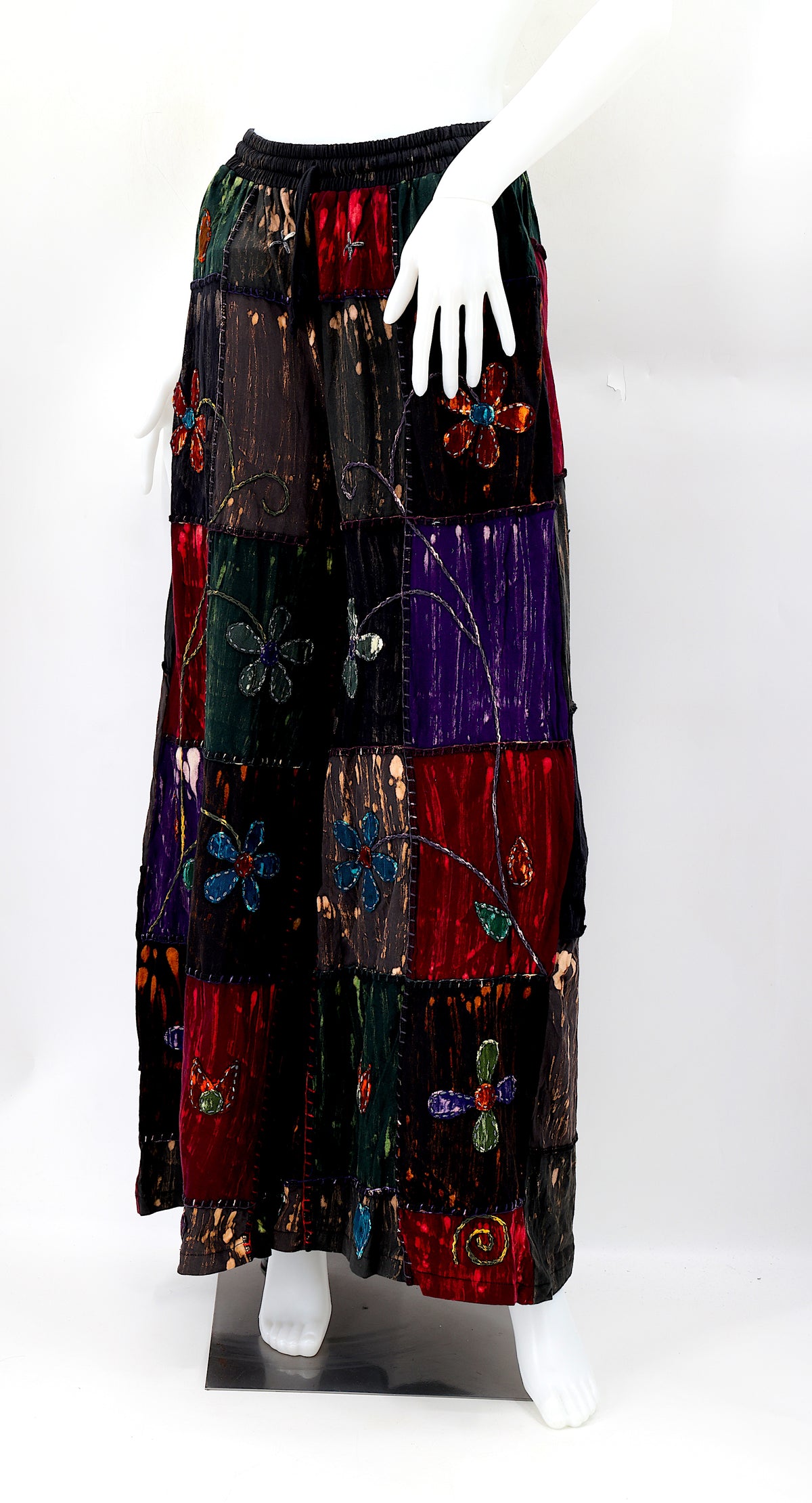 Artisan-crafted cotton trousers with floral stitching and soft, flowing fabric