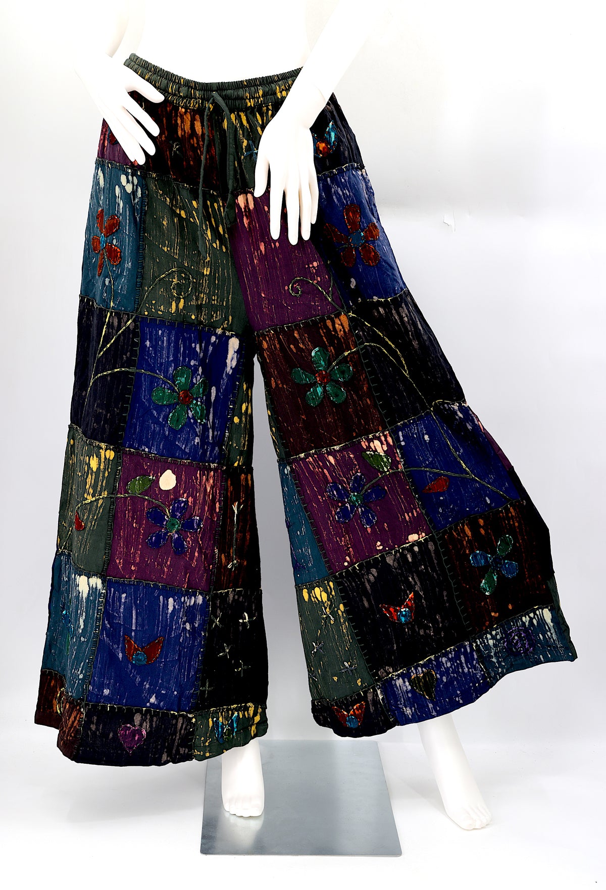Front view of handmade flower embroidered patchwork wide-leg cotton harem pants