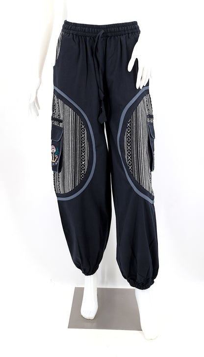 Front view of handmade moon and mushroom embroidered straight-leg harem pants