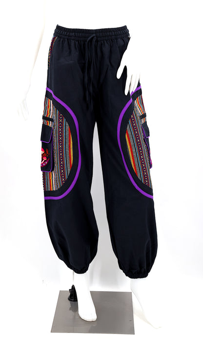 Front view of handmade moon and mushroom embroidered straight-leg harem pants