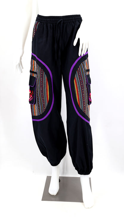 Front view of handmade moon and mushroom embroidered straight-leg harem pants