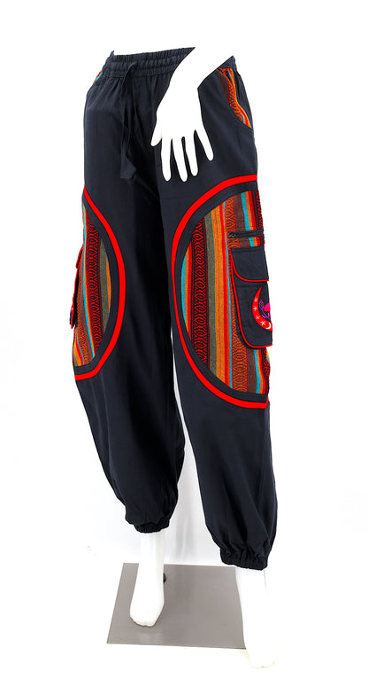 Front view of handmade moon and mushroom embroidered straight-leg harem pants