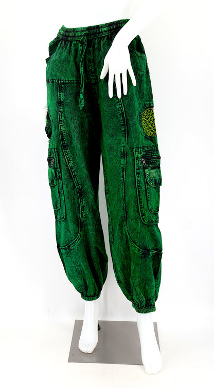 Close-up of dark green embroidered Flower of Life symbol on handmade trousers