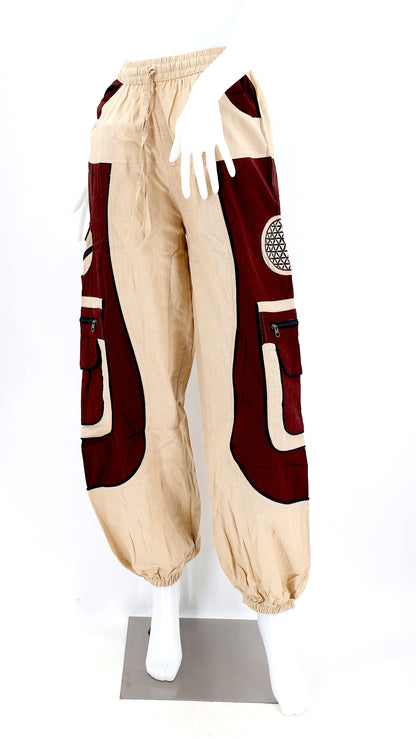 Close-up of beige brown embroidered Flower of Life symbol on handmade trousers