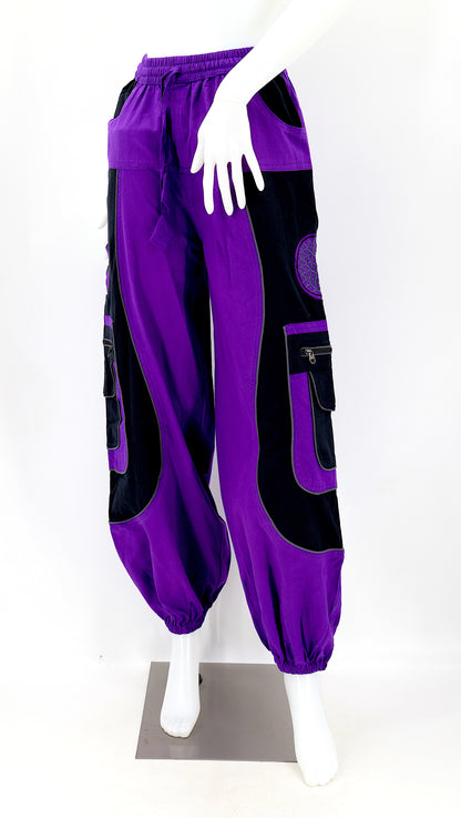 Close-up of purple embroidered Flower of Life symbol on handmade trousers