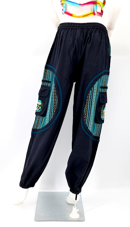 Back view of black and teal blue handmade moon and mushroom embroidered straight-leg harem pants