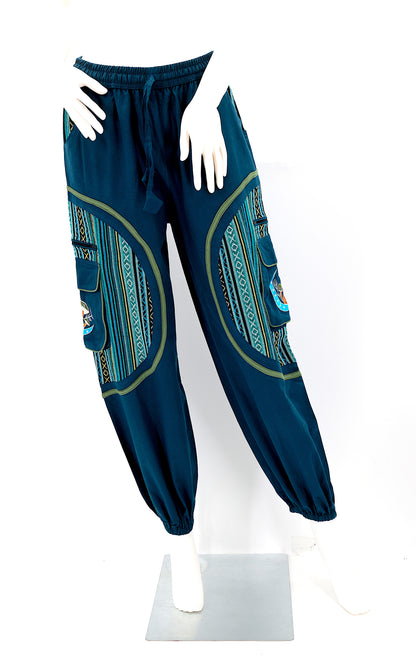 Front view of teal blue handmade moon and mushroom embroidered straight-leg harem pants