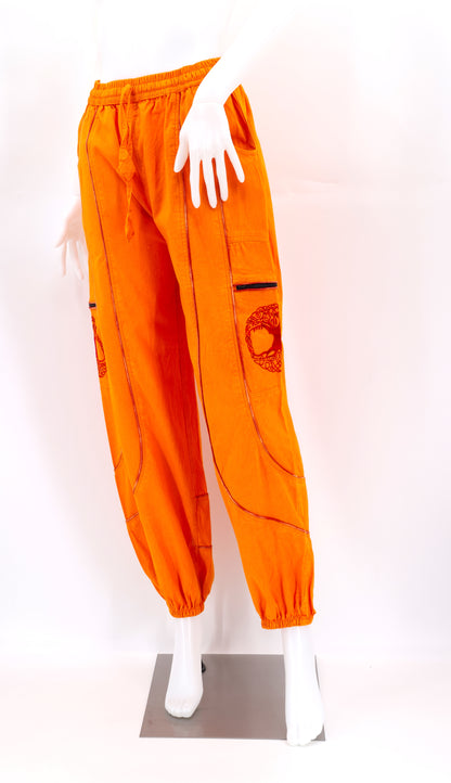 Front view of orange handmade Tree of Life embroidered straight-leg harem pants
