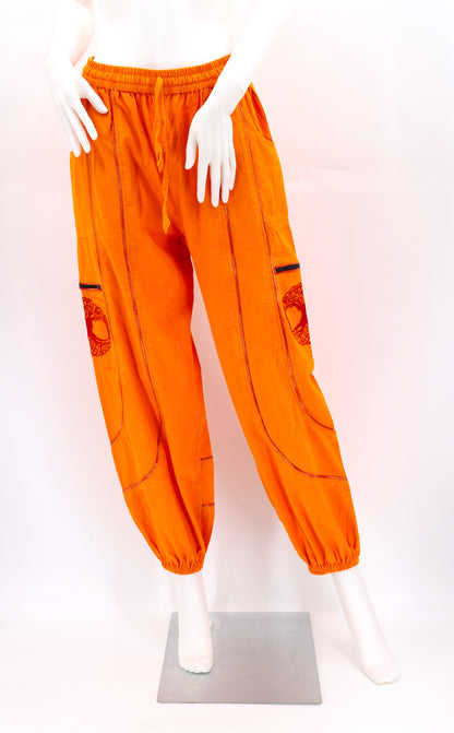 Front view of orange handmade Tree of Life embroidered straight-leg harem pants