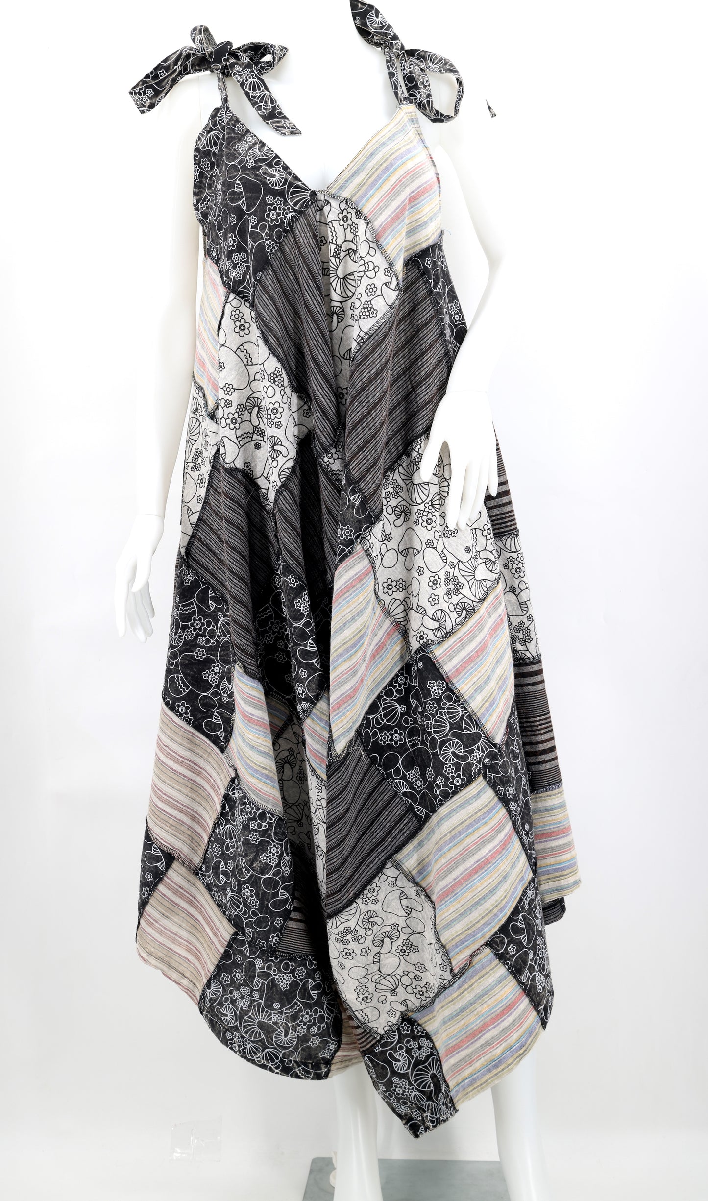 Patchwork dress with floral and striped patterns on a white background