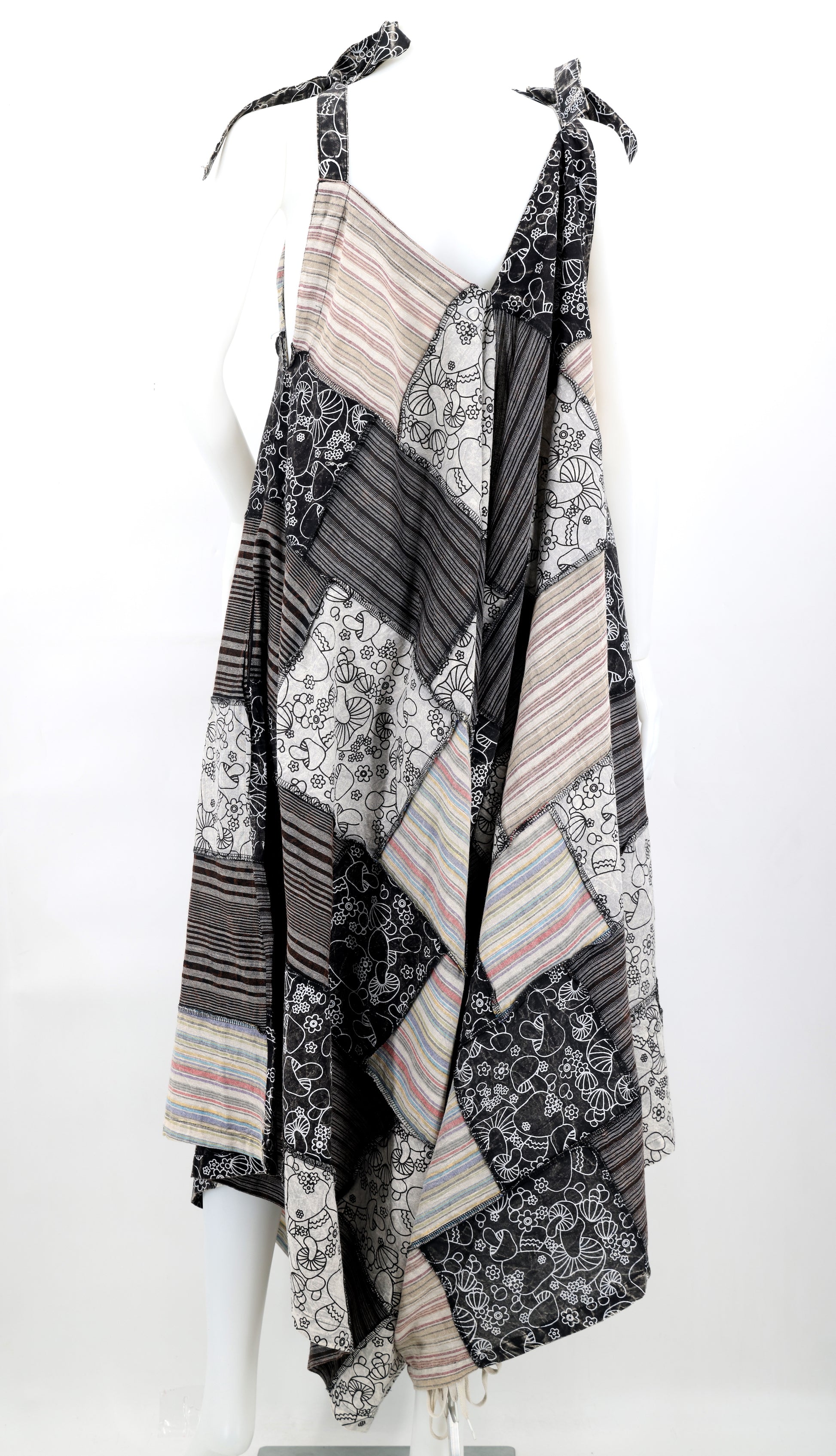 Patterned scarf draped over a mannequin on a white background