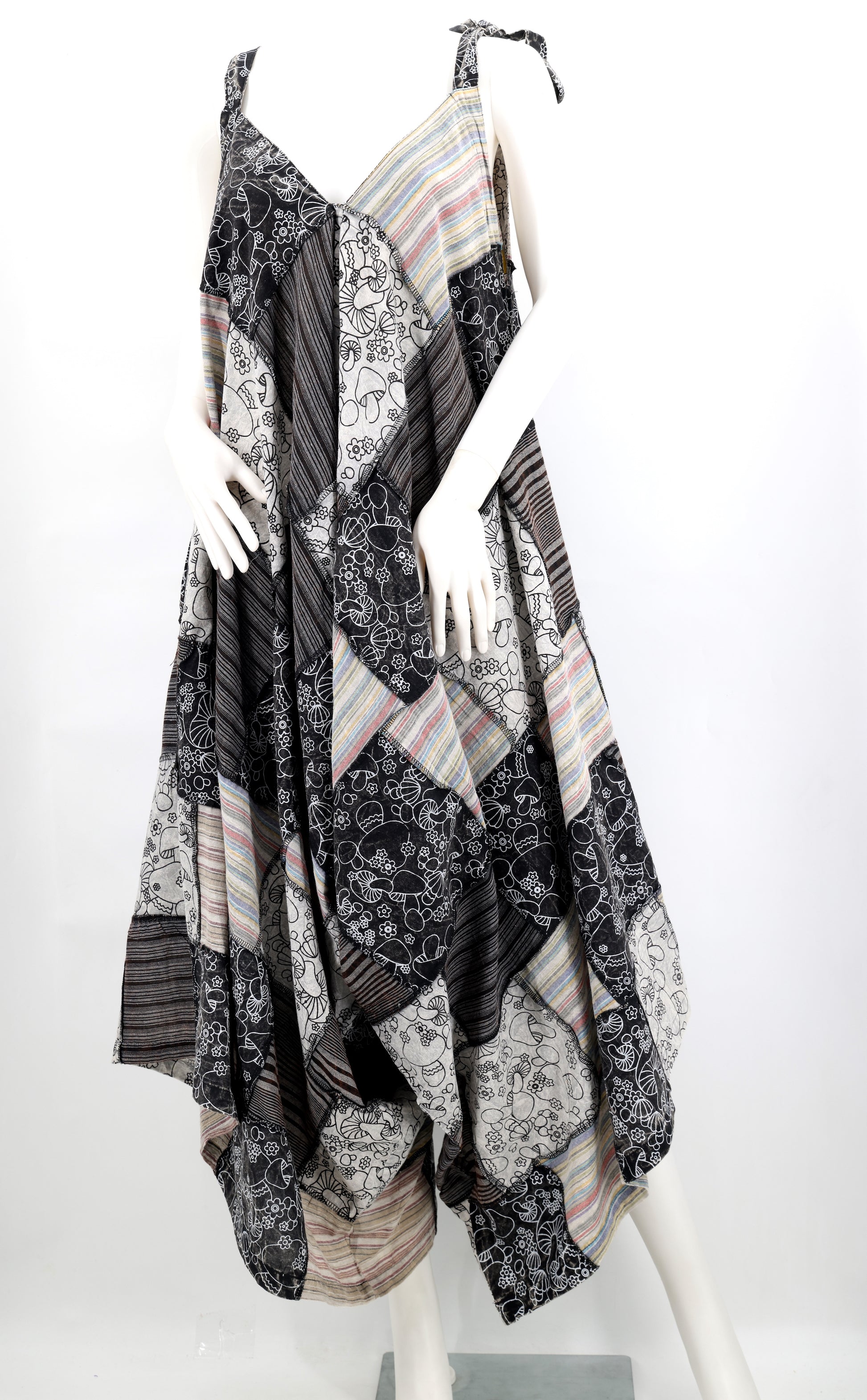 Mannequin wearing a patterned dress with a white background